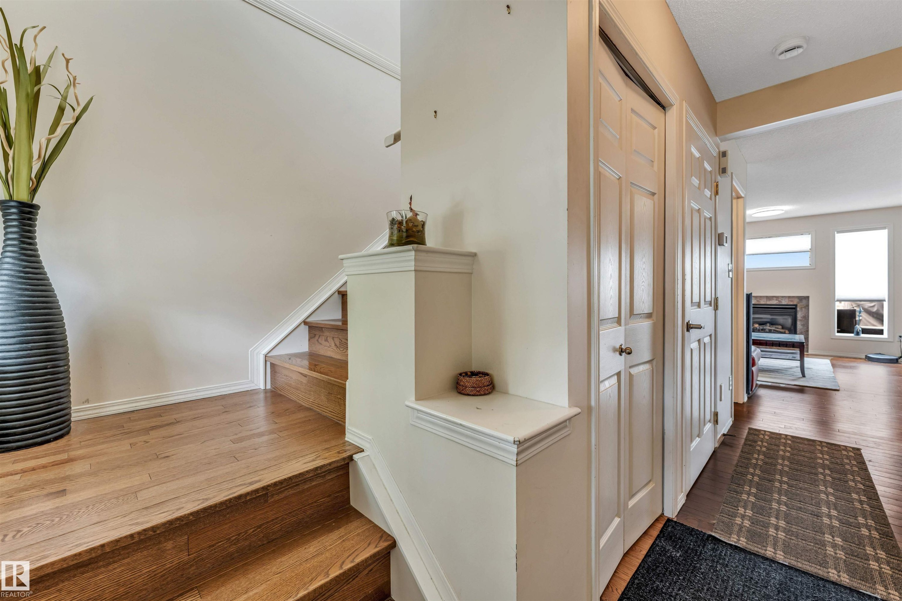 Light wood-finish flooring with coordinating staircase - 3032 31 Avenue, Edmonton, AB - Indoor Photo Showing Other Room