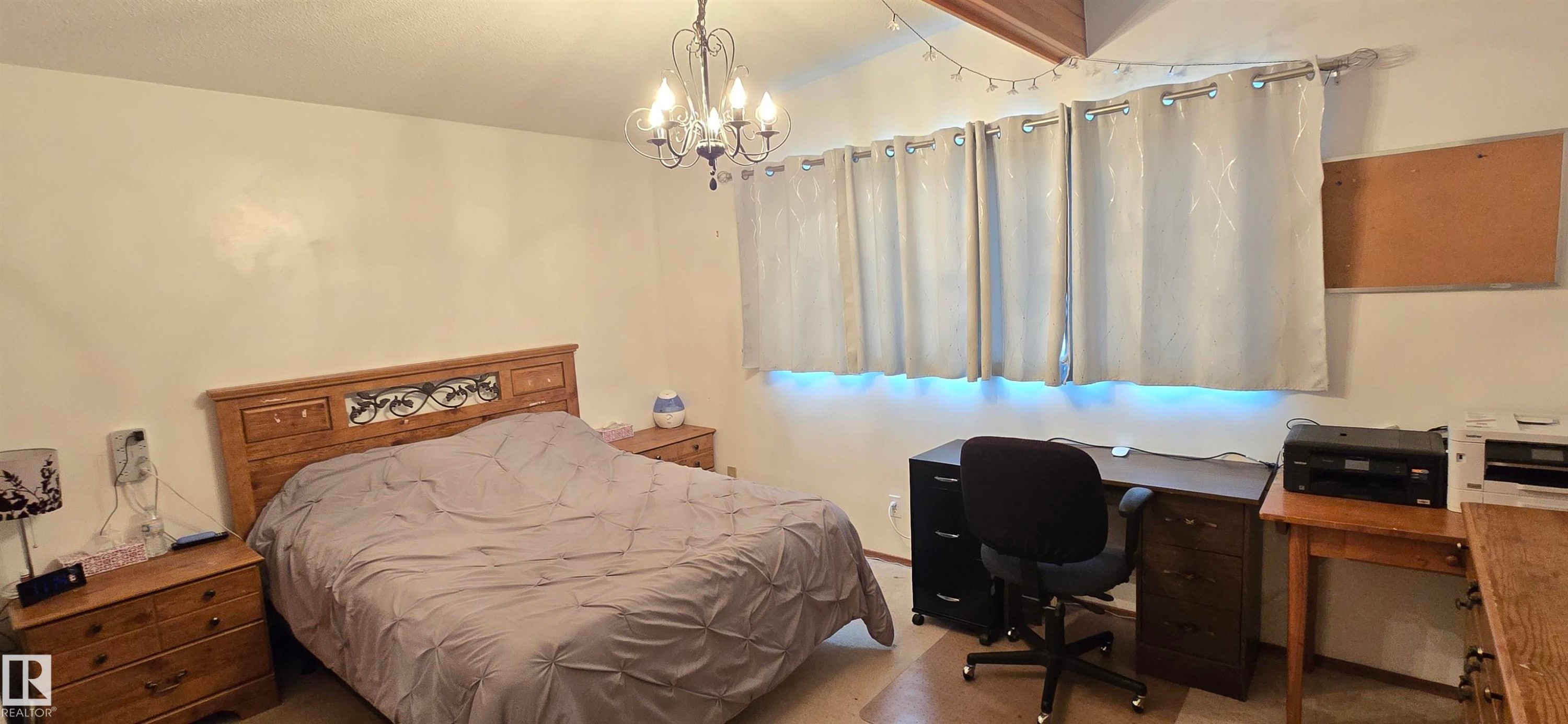 Room featuring light-colored walls and wood-finish flooring - 5304 49 Street, Two Hills, AB - Indoor Photo Showing Bedroom