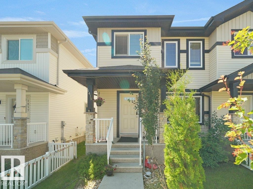Contemporary exterior with light-colored siding and dark trim accents - 1419 27 Av, Edmonton, AB