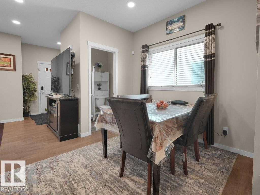 Dining area featuring recessed lighting and wood-finish flooring - 1419 27 Av, Edmonton, AB