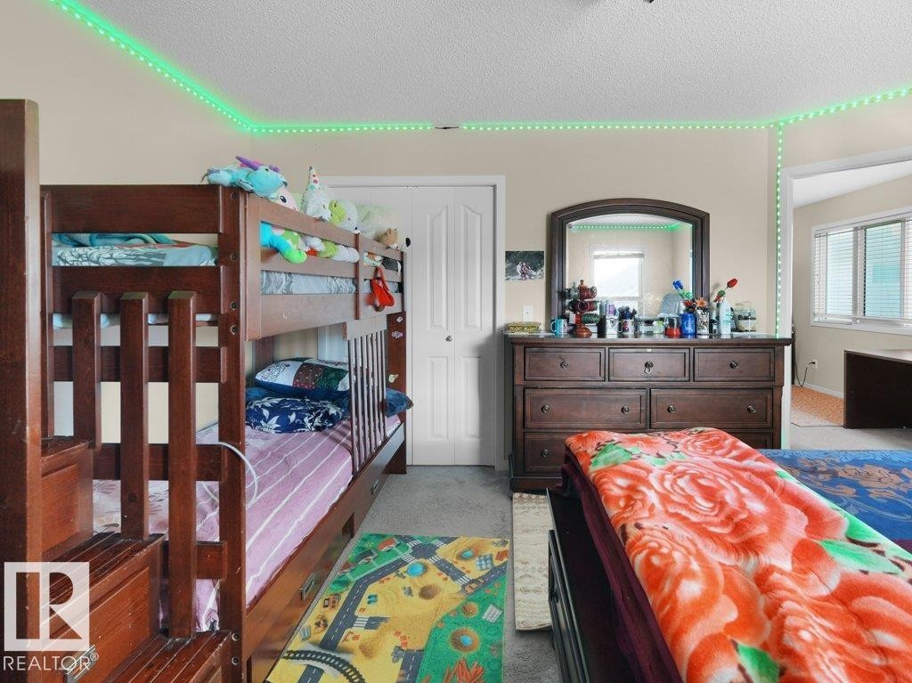 Bedroom featuring carpet flooring and a neutral color palette - 1419 27 Av, Edmonton, AB