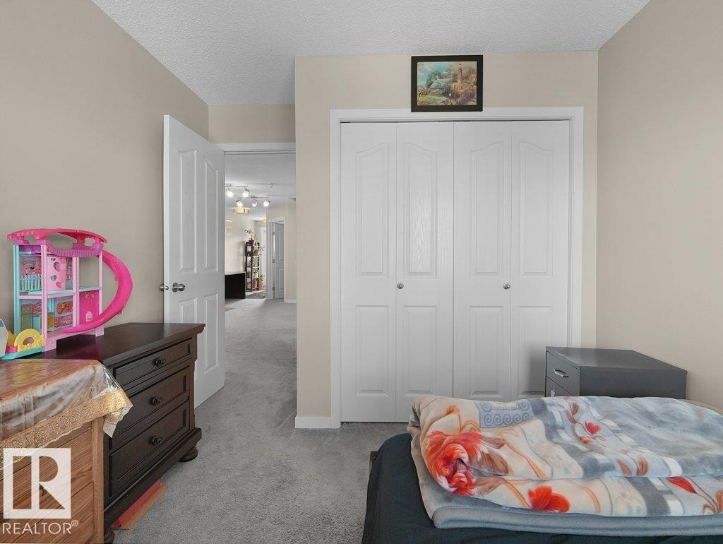 Carpeted room with neutral wall paint and textured ceiling - 1419 27 Av, Edmonton, AB