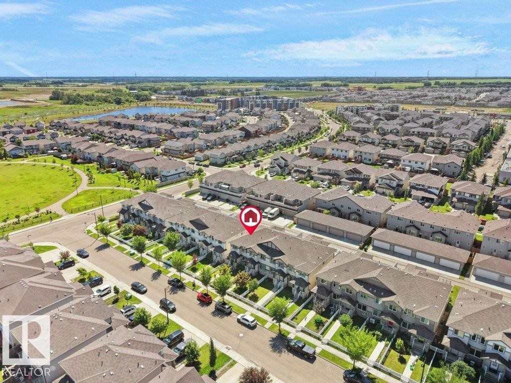 Aerial perspective of a developed residential community featuring rows of townhomes and detached properties - 1419 27 Av, Edmonton, AB