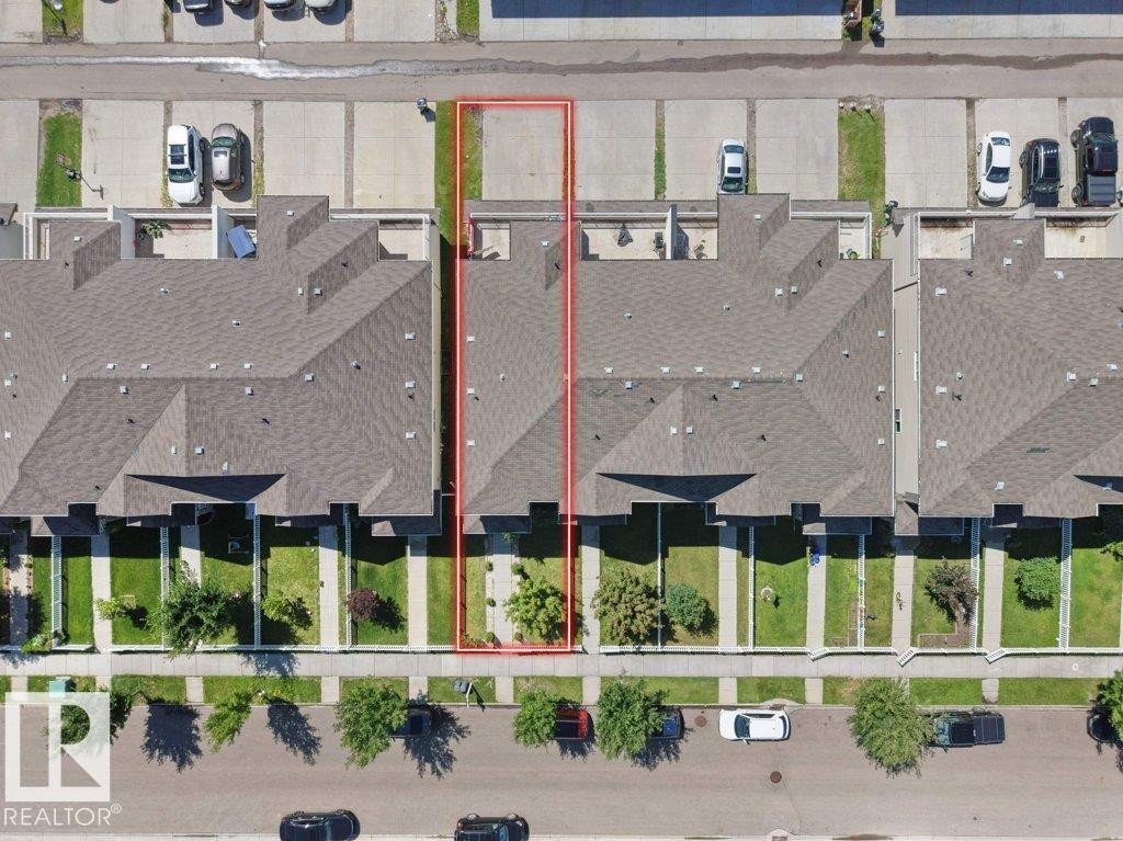 Aerial view of a residential property with a gabled roof and a private concrete patio - 1419 27 Av, Edmonton, AB