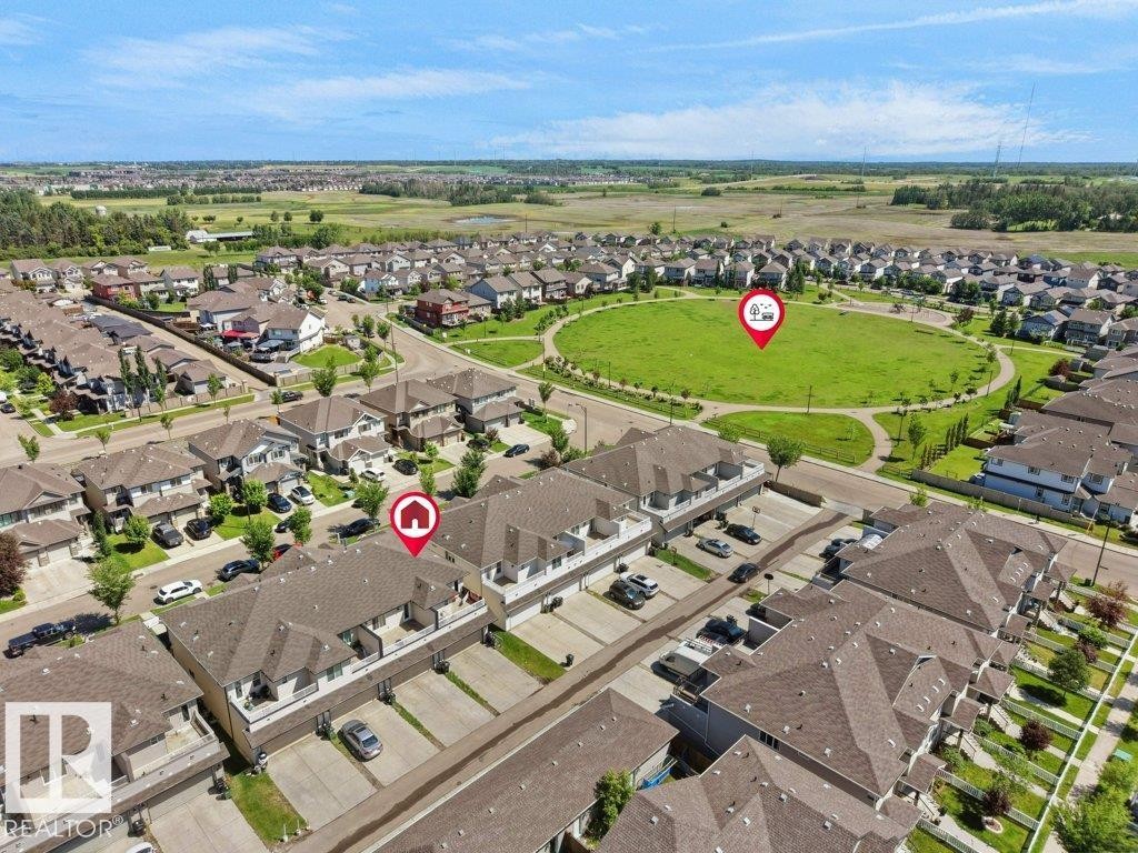 Aerial view showcasing a residential community with numerous detached homes and townhome-style properties - 1419 27 Av, Edmonton, AB