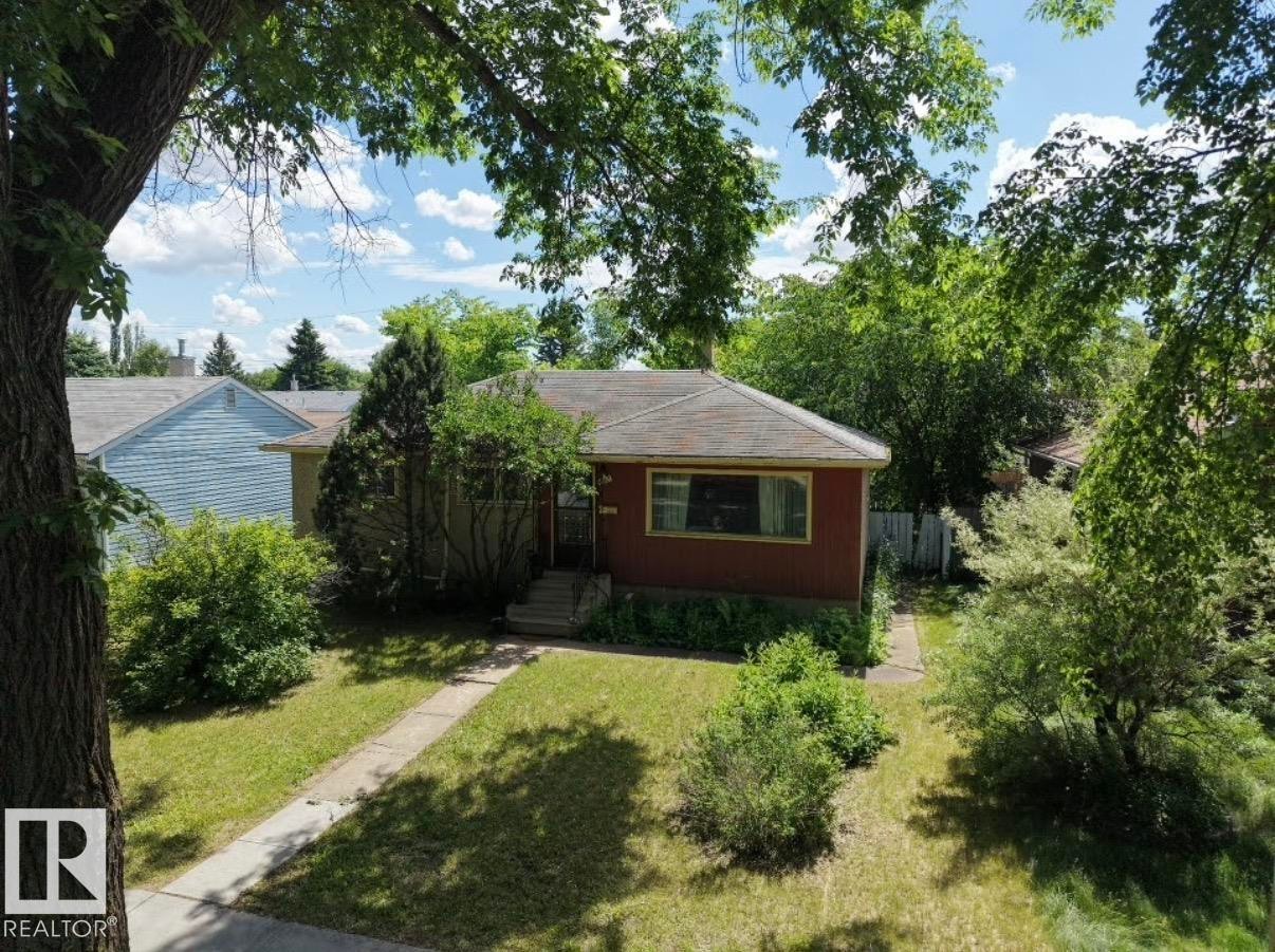 Ranch-style exterior with red siding and a brown shingle roof - 8719 67 Avenue Nw, Edmonton, AB - Outdoor