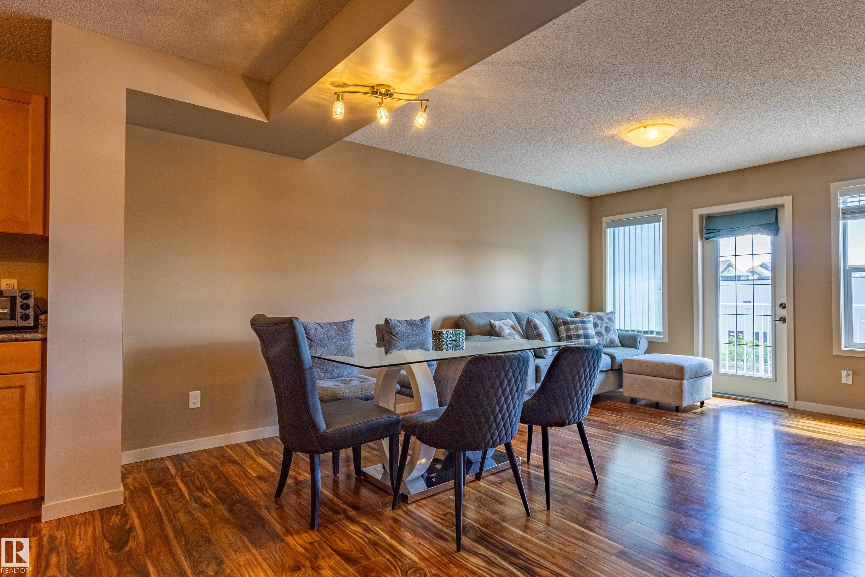 Open concept living area with wood-finish flooring - 13 1816 Rutherford Road, Edmonton, AB