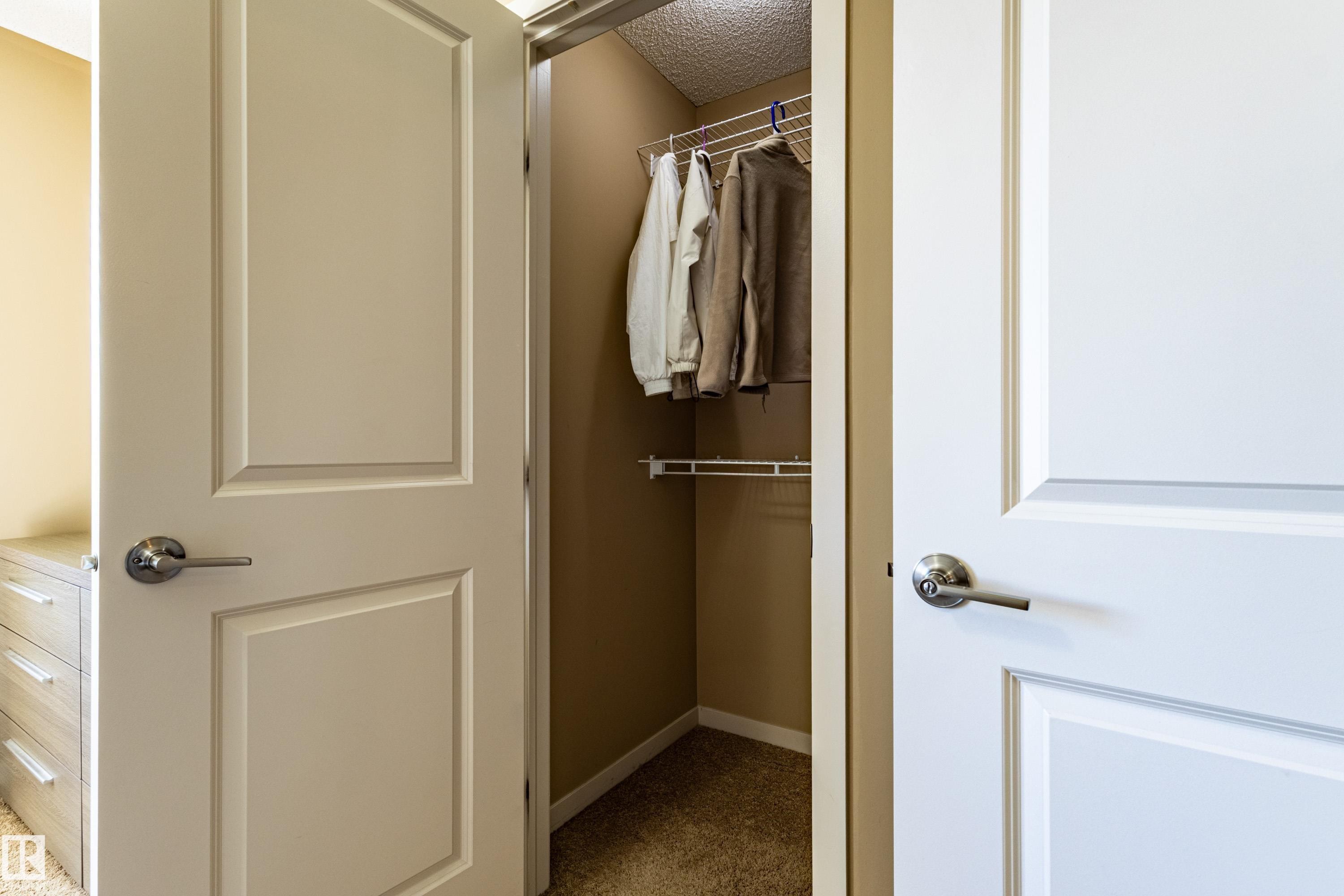 Recessed closet featuring wire shelving and hanging rod - 13 1816 Rutherford Road, Edmonton, AB