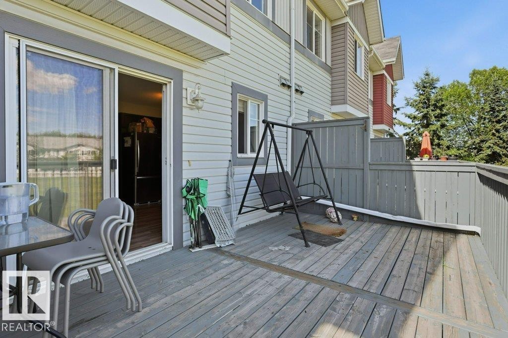 Expansive wood deck with privacy fencing and direct interior access via sliding glass doors - 30 1404 Hermitage Road, Edmonton, AB
