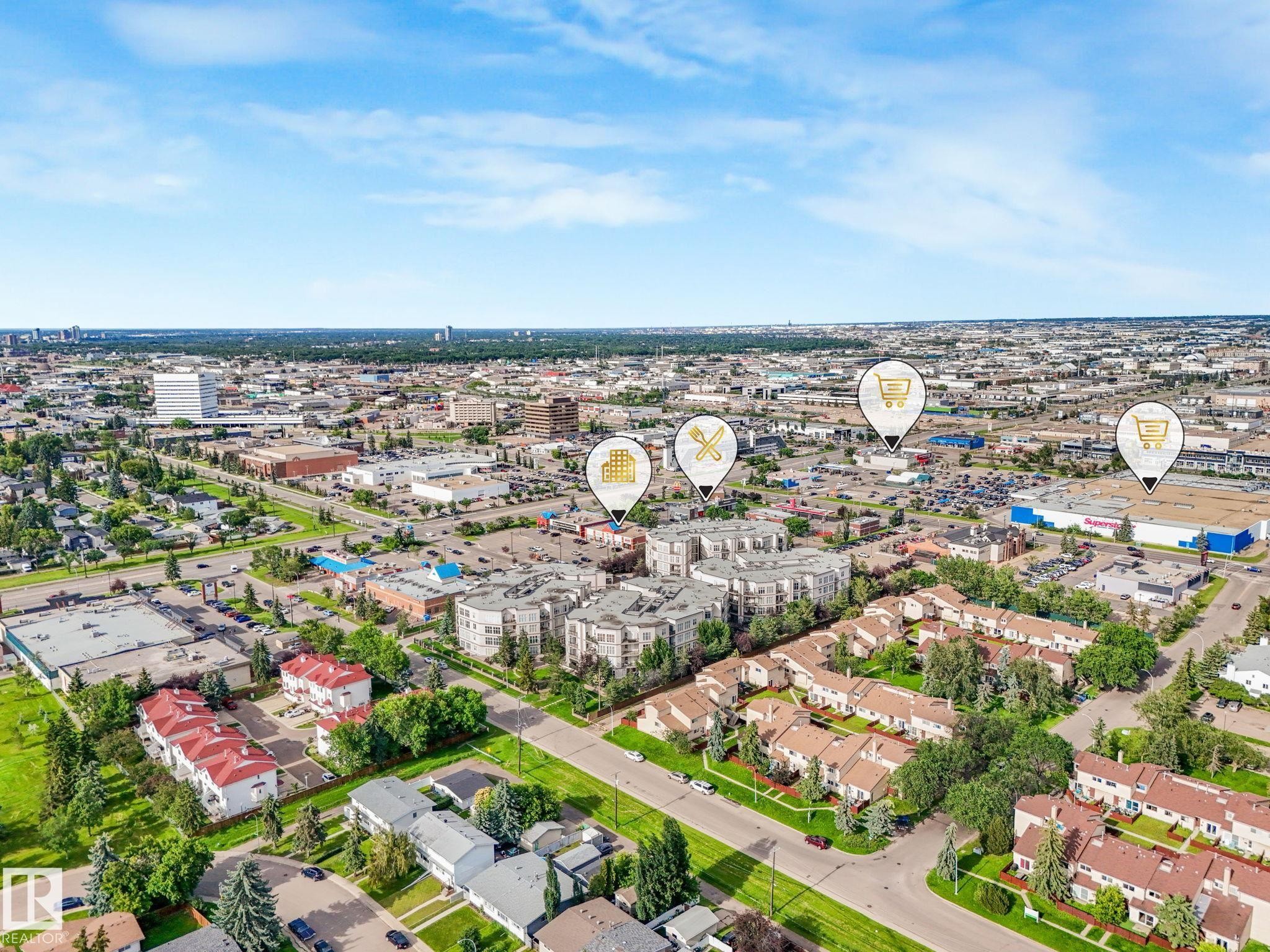 Aerial perspective showcasing a mixed-use urban landscape with commercial and residential properties - 150 4827 104A Street, Edmonton, AB