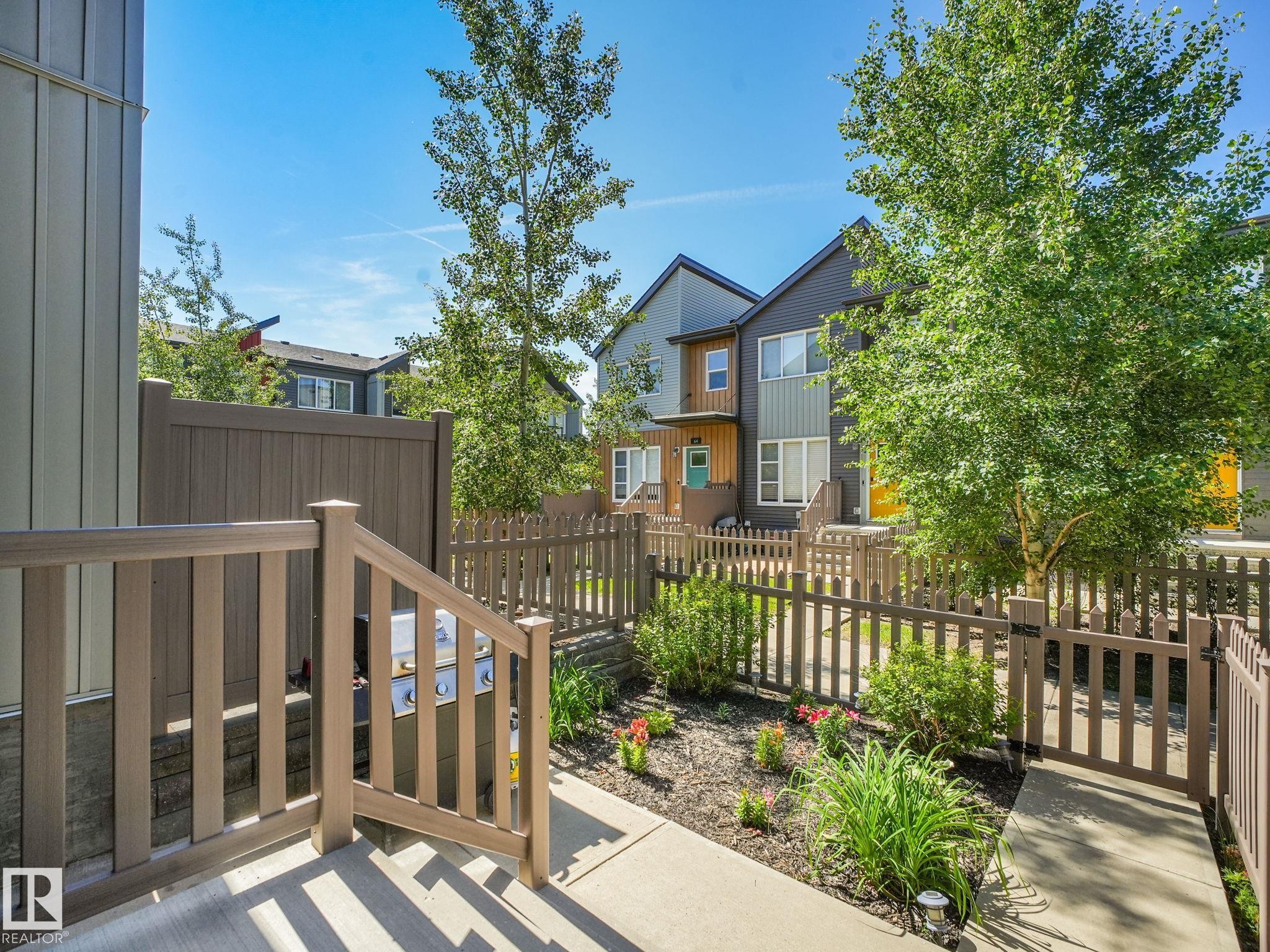 Outdoor patio featuring a built-in grill, composite railings, and a privacy fence - #55 4470 Prowse Rd Sw, Edmonton, AB - Outdoor With Deck Patio Veranda