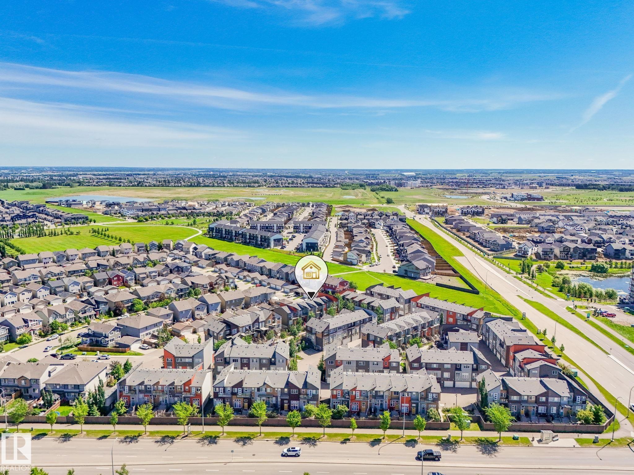 Aerial perspective showcasing a residential community with varied architectural styles - #55 4470 Prowse Rd Sw, Edmonton, AB - Outdoor With View