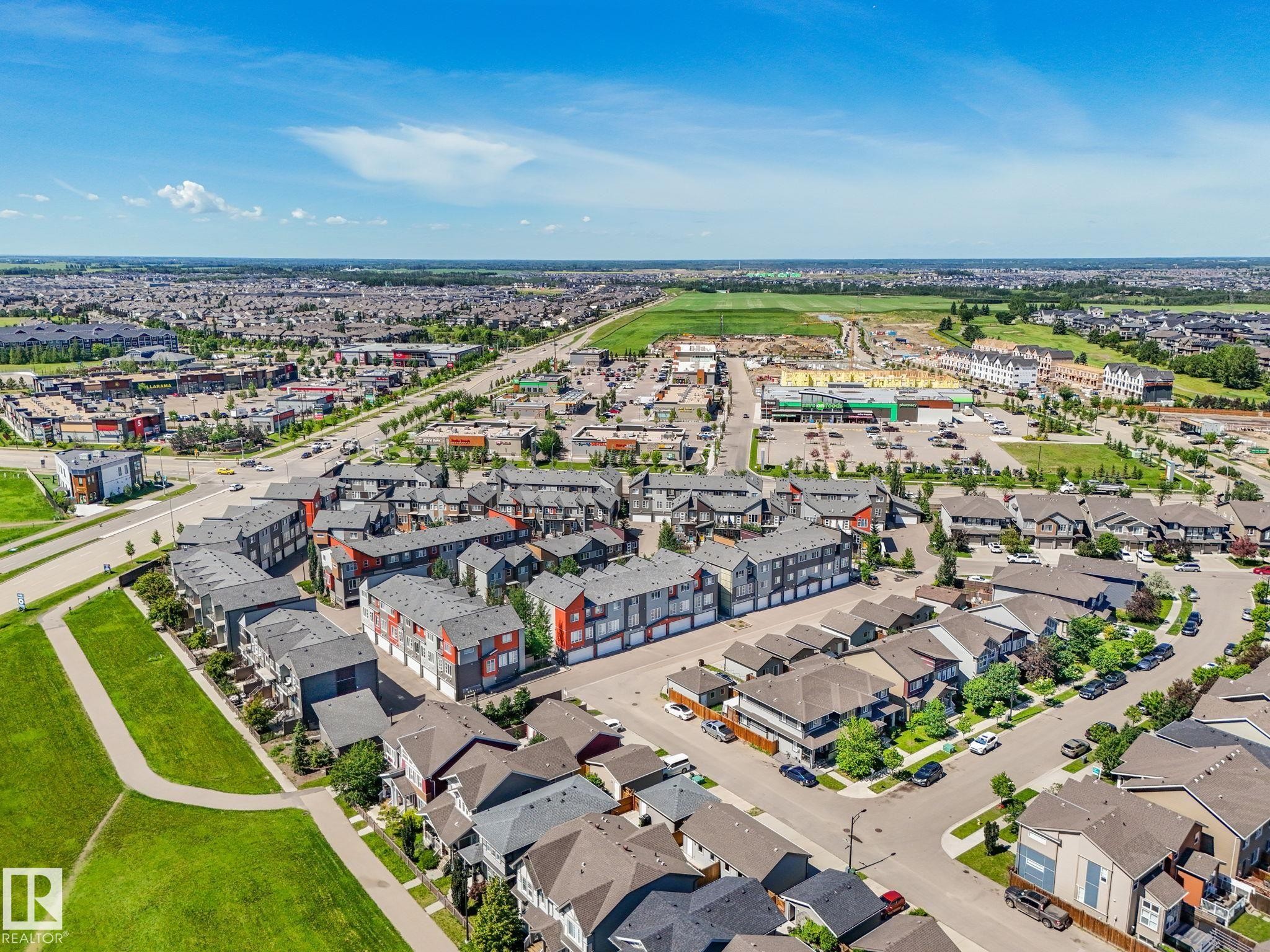Expansive aerial perspective showcasing a residential community with varied housing styles - #55 4470 Prowse Rd Sw, Edmonton, AB - Outdoor With View