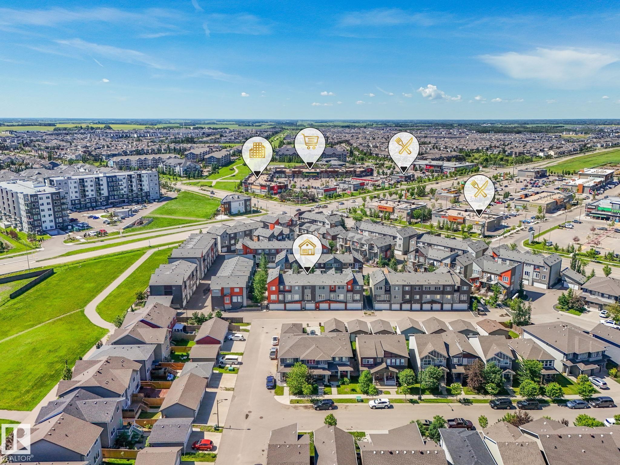Aerial perspective showcasing a residential development with a mix of detached homes, townhomes, and multi-story apartment buildings - #55 4470 Prowse Rd Sw, Edmonton, AB - Outdoor With View