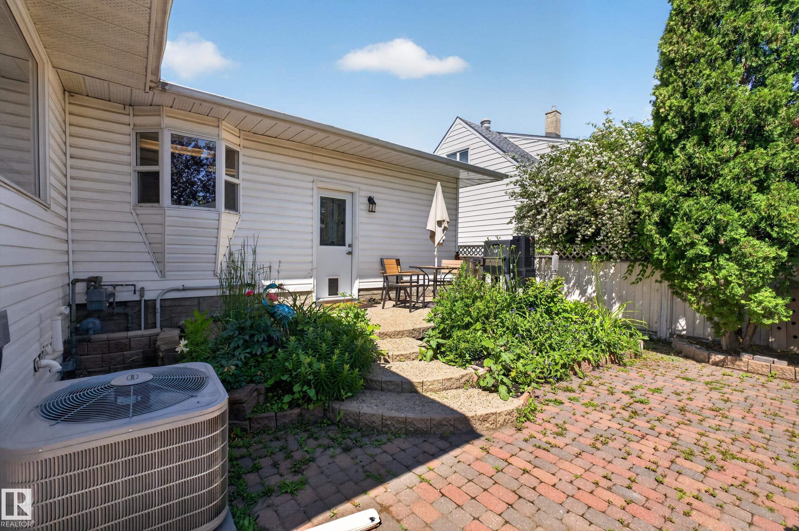 Brick paver patio with tiered stone steps leading to a secondary patio area - 11015 122 Street, Edmonton, AB