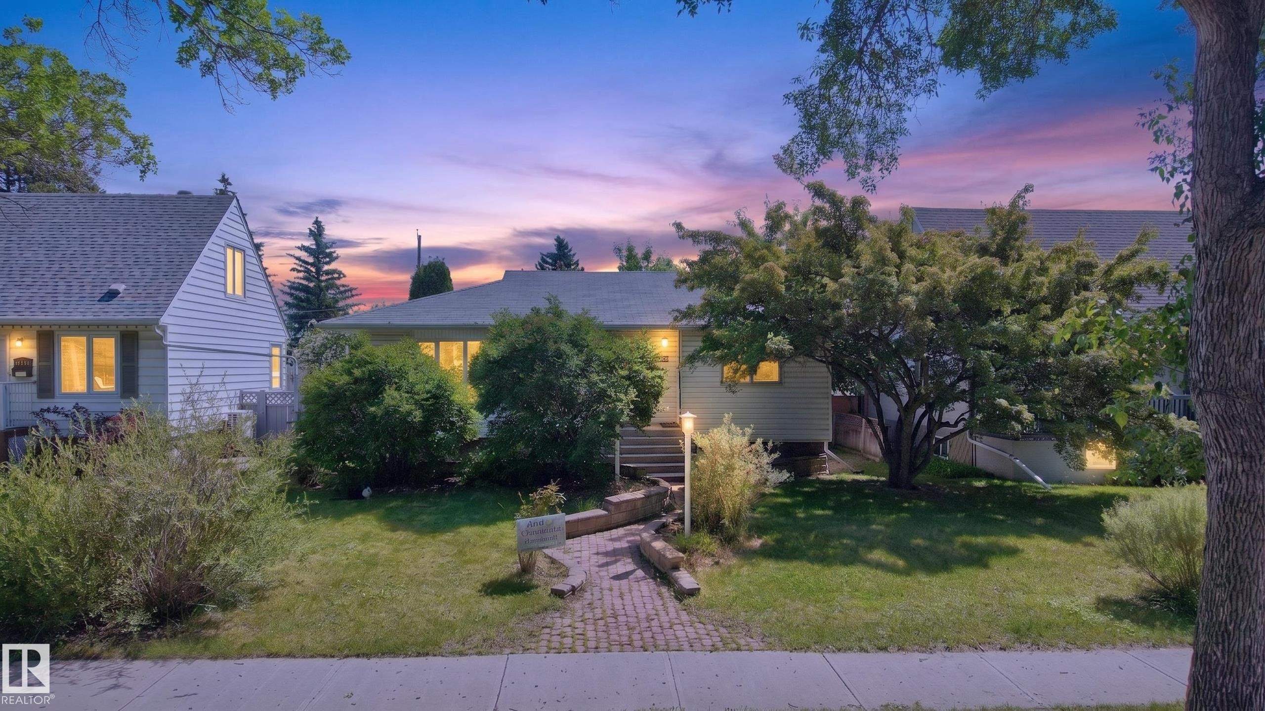 Ranch-style exterior with a gabled roof, featuring a brick paver pathway leading to the front entry - 11015 122 Street Nw, Edmonton, AB