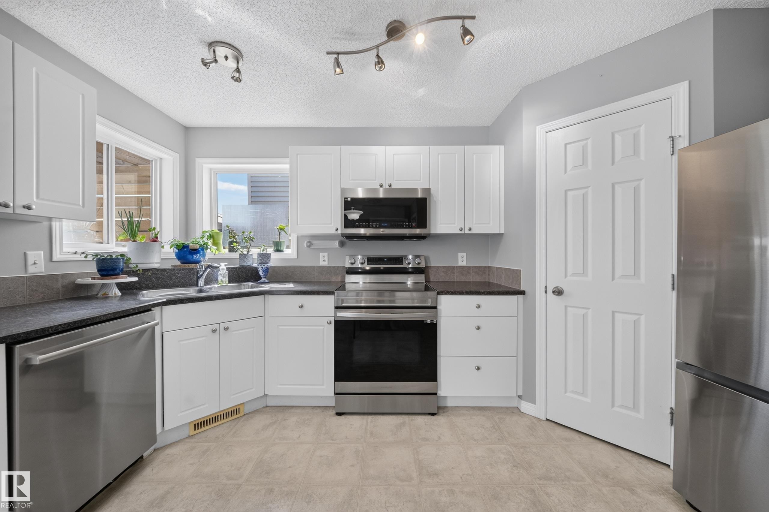 709 83 St Sw, Edmonton, AB - Indoor Photo Showing Kitchen With Stainless Steel Kitchen With Double Sink