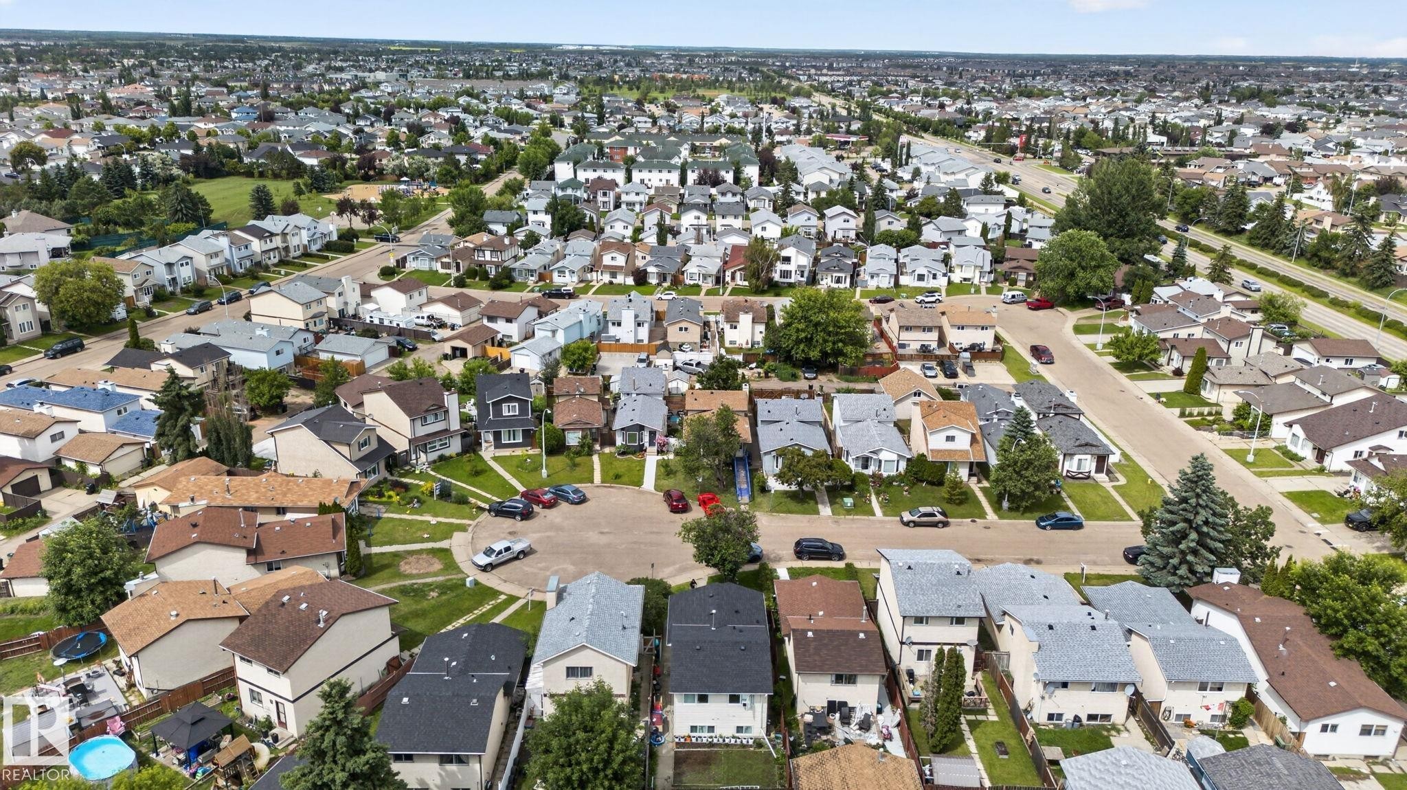 Residential neighborhood featuring various housing styles and abundant mature trees - 8316 157 Avenue, Edmonton, AB