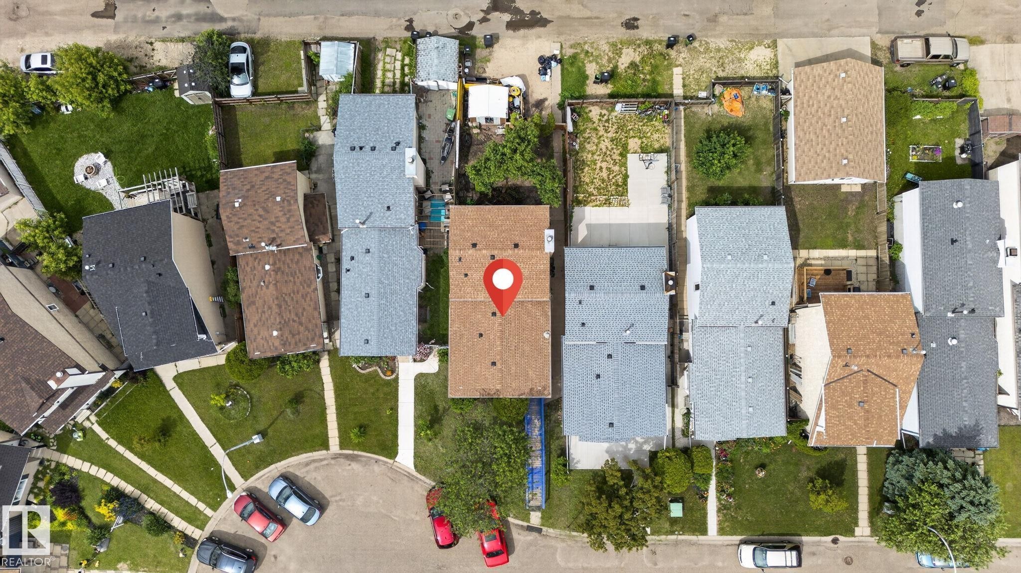 Property with a brown shingle roof, two distinct backyard areas, and perimeter fencing - 8316 157 Avenue, Edmonton, AB