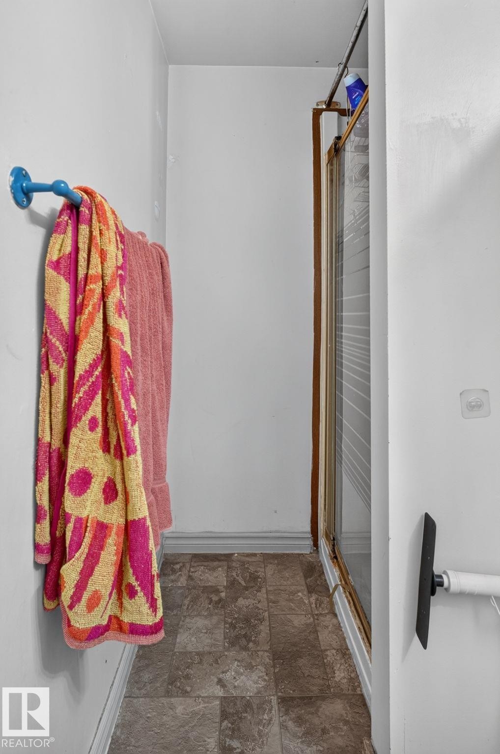 Shower enclosure with clear glass door and a tiled flooring - 8316 157 Avenue, Edmonton, AB