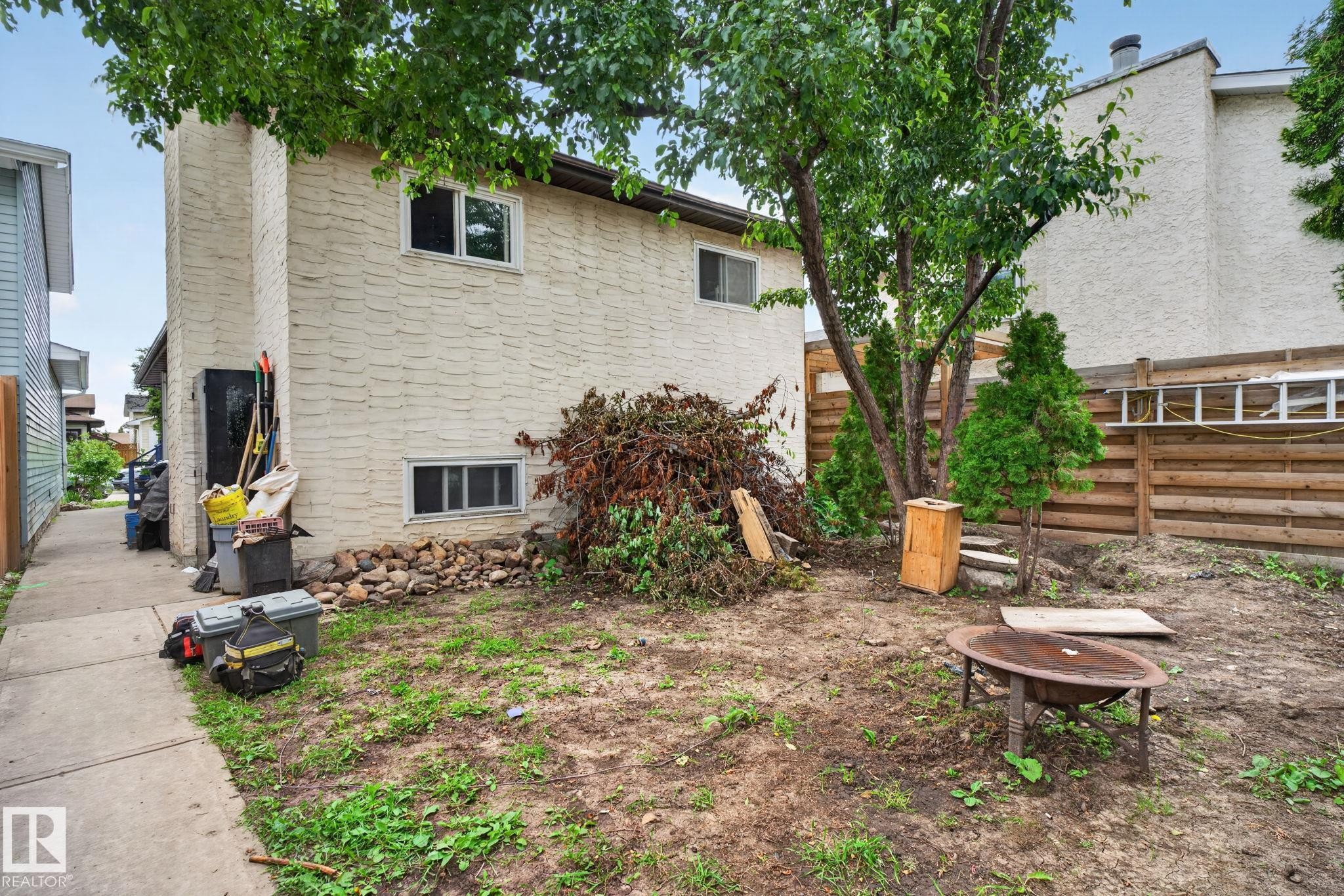 Rear exterior with textured siding and upper-level windows - 8316 157 Avenue, Edmonton, AB