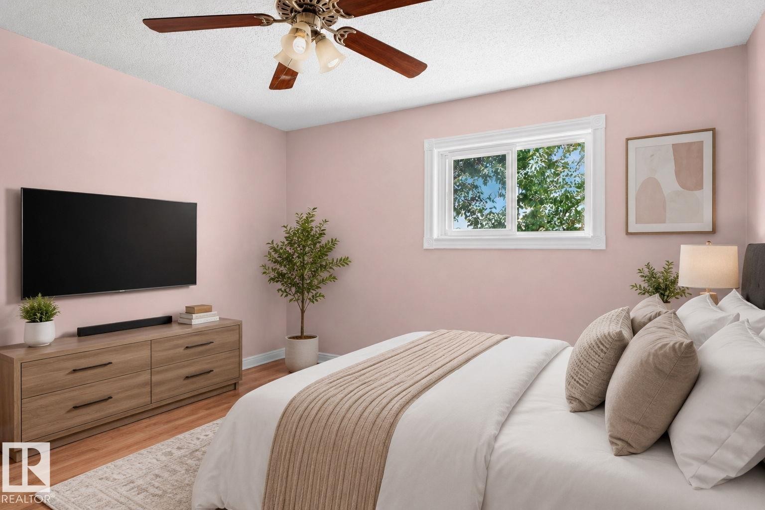 Room with wood-finish flooring, a white-framed window, and a ceiling fan with light fixture - 8316 157 Avenue, Edmonton, AB