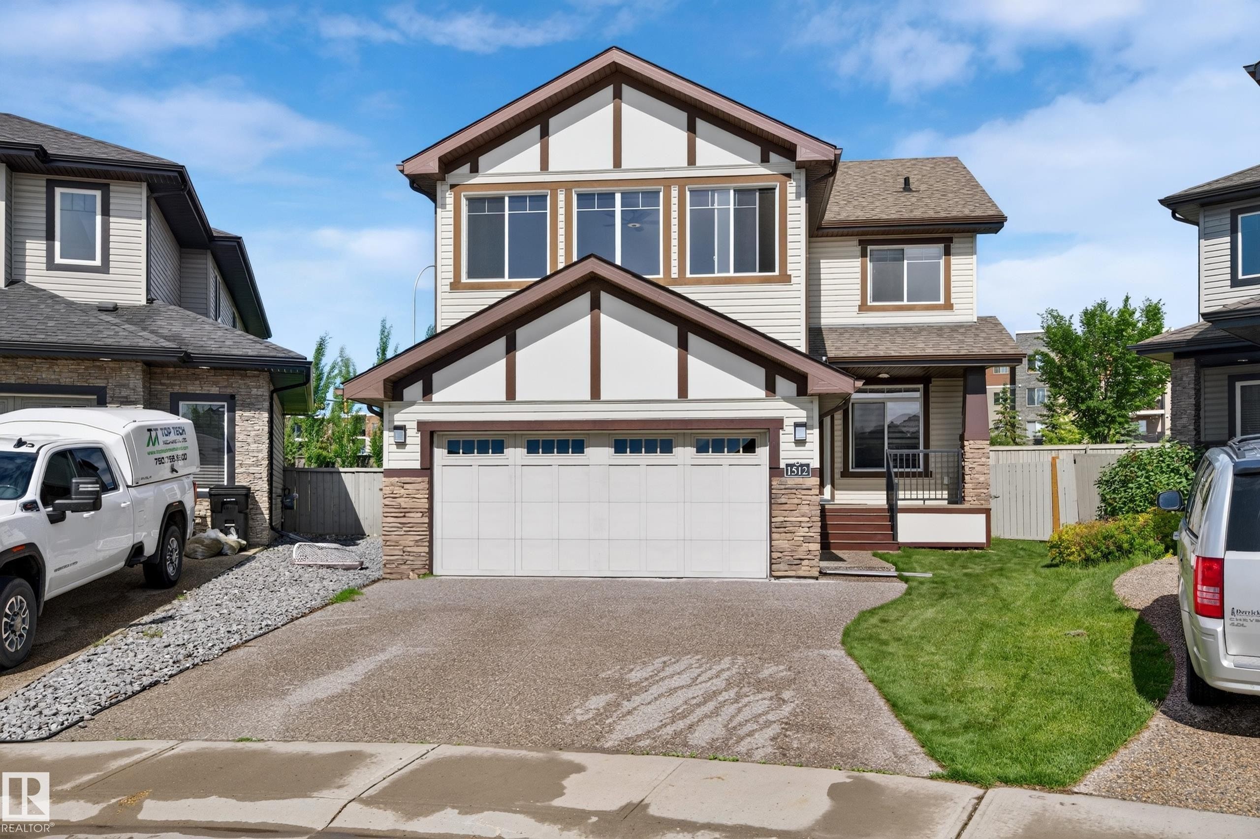 Contemporary two-story residence featuring light-toned siding and dark trim accents - 1512 Cunningham Cape, Edmonton, AB