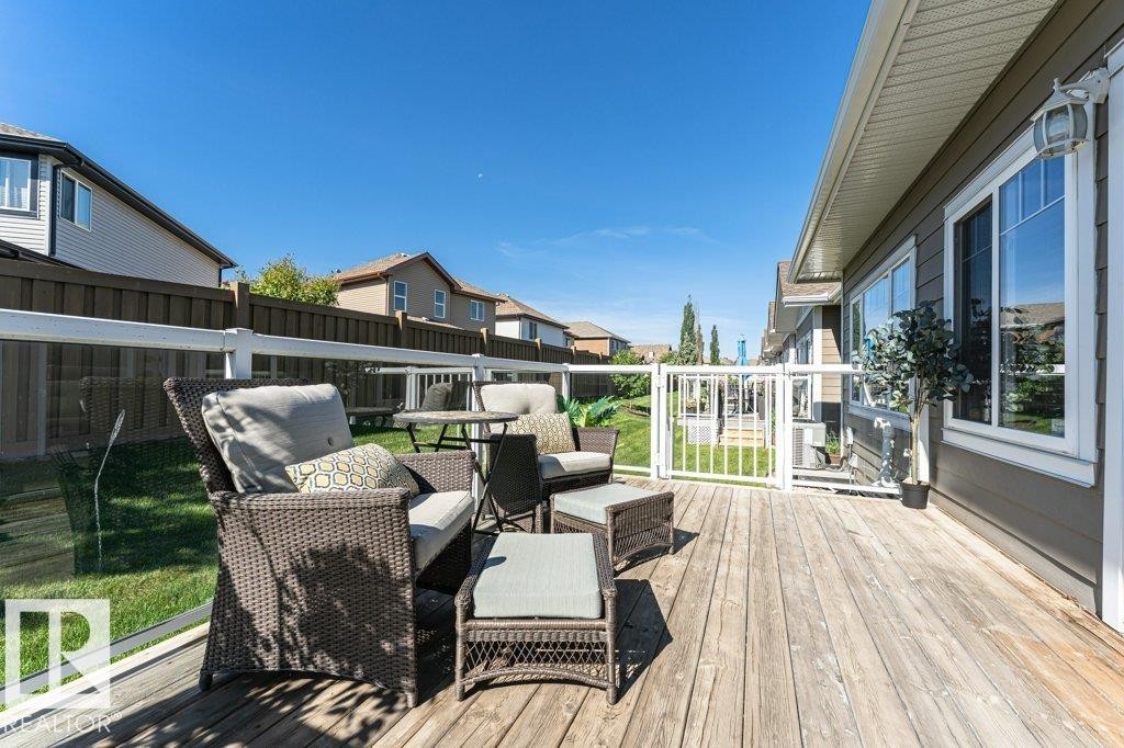 Expansive outdoor wood deck with a clear panel railing system - 15 175 Mcconachie Drive, Edmonton, AB