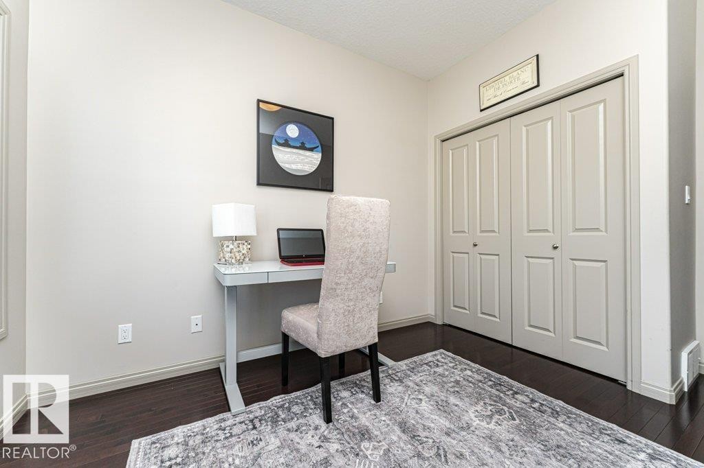 Room featuring dark wood-finish flooring and light-toned walls - 15 175 Mcconachie Drive, Edmonton, AB