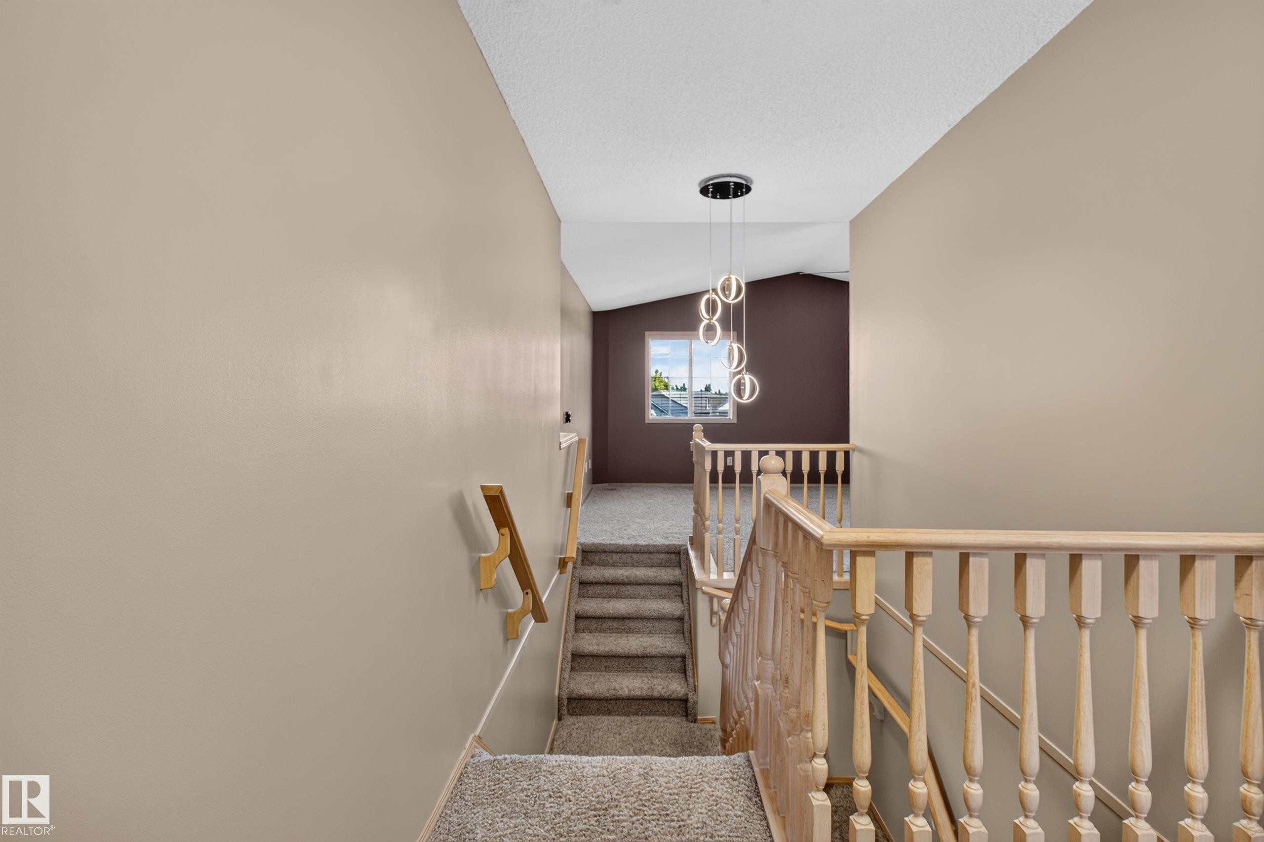 Stairwell with carpeted steps and light wood railings - 13406 32A Street, Edmonton, AB