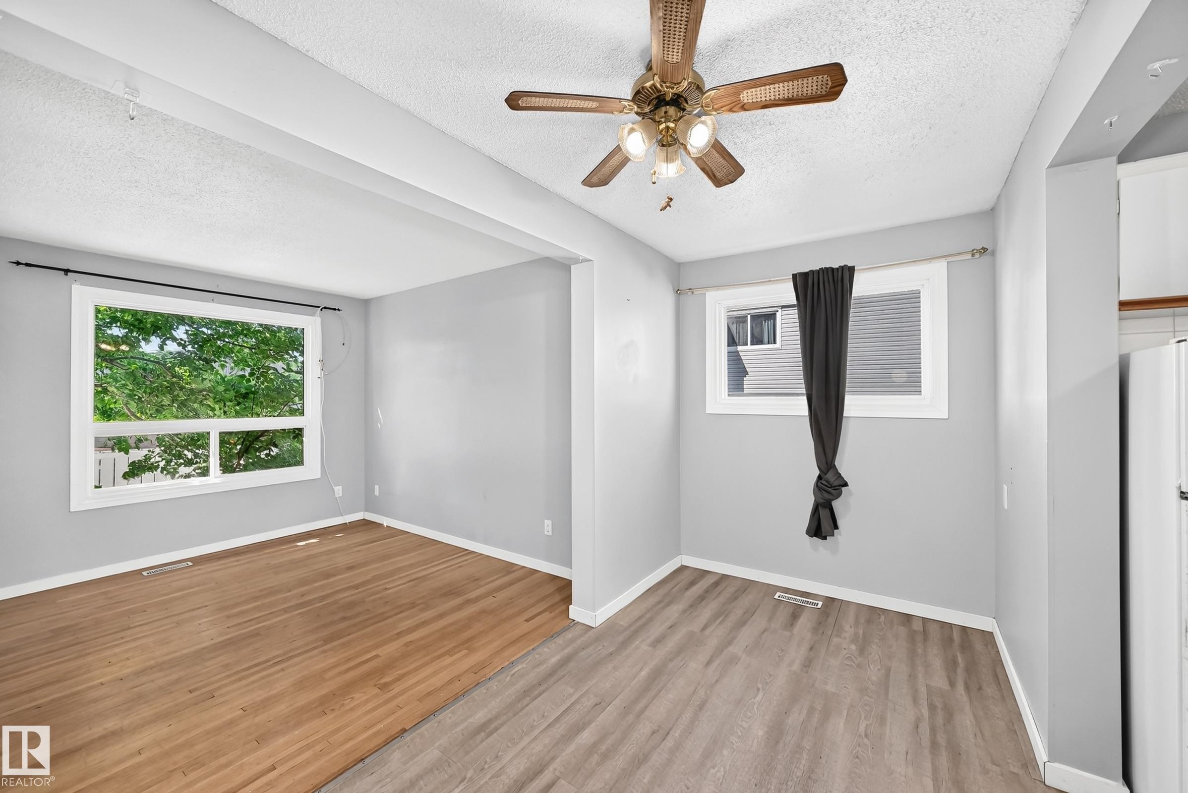 Open-concept room featuring two distinct flooring types: wood-finish and plank-style - 355 Northgate Terrace, Edmonton, AB