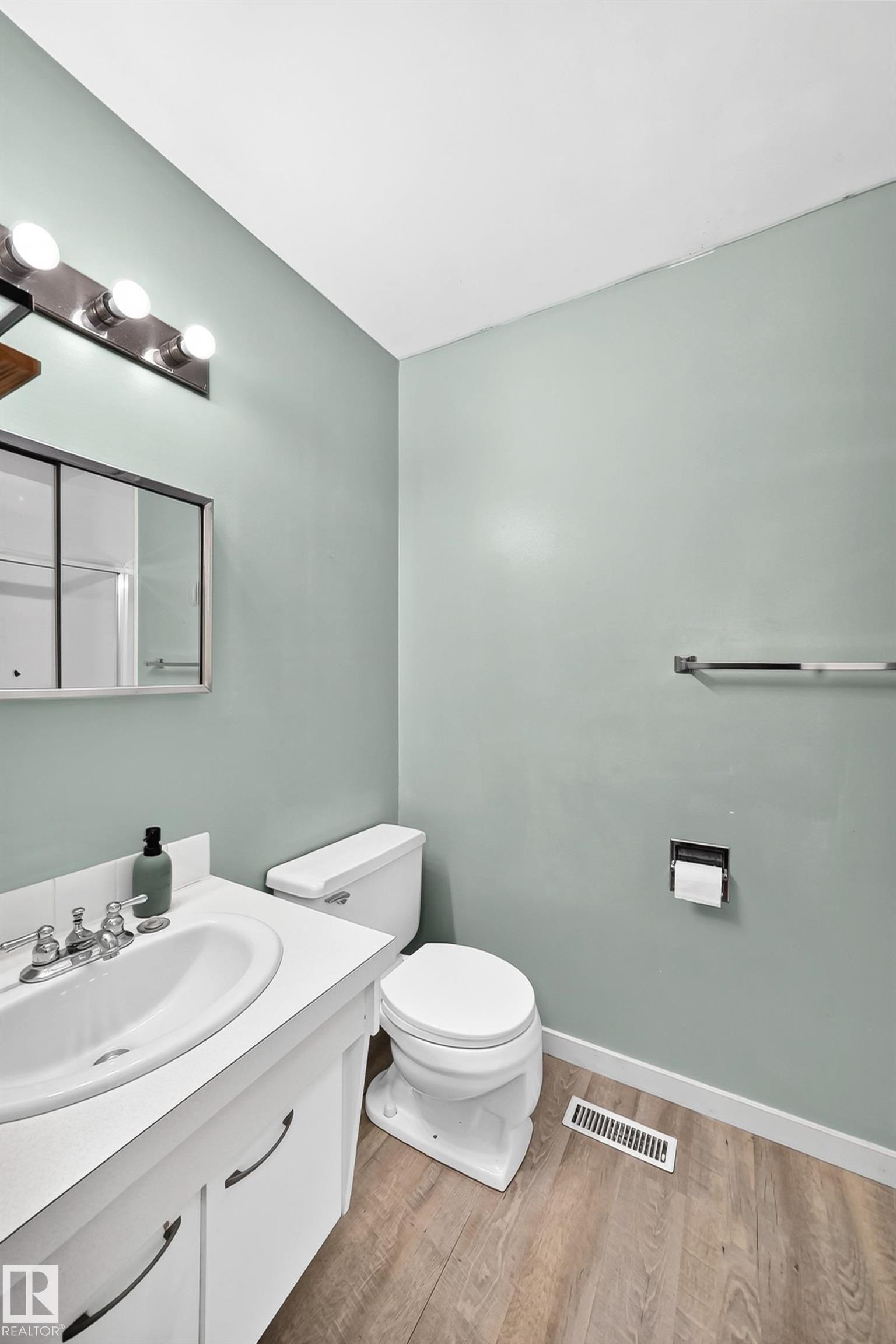 Bathroom featuring a white vanity with an integrated sink, chrome faucet, and under-sink cabinetry - 355 Northgate Terrace, Edmonton, AB