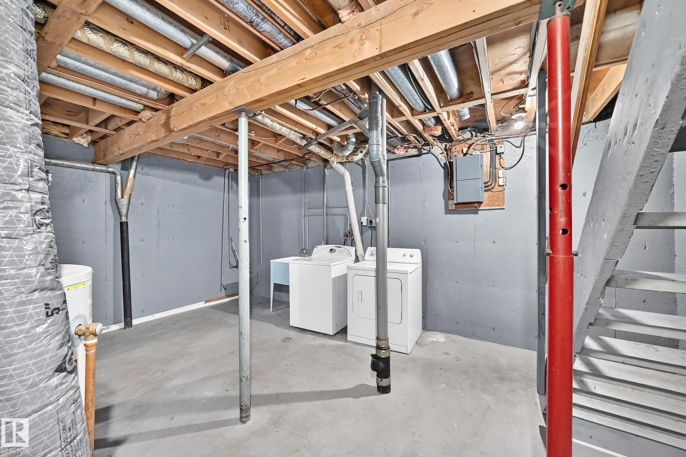 Utility area featuring a concrete floor, painted block walls, exposed ceiling joists, laundry hookups, and a utility sink - 355 Northgate Terrace, Edmonton, AB