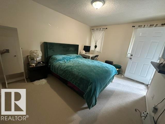 Carpeted room with a wall-mounted flush light fixture - 18020 96 Avenue, Edmonton, AB