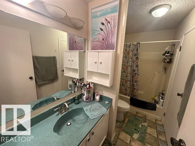 Bathroom featuring a vanity with an integrated basin and a full-width mirror - 18020 96 Avenue, Edmonton, AB