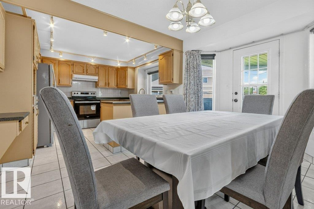 Dining area featuring white ceramic tile flooring - 16524 99 Street Nw, Edmonton, AB - Indoor