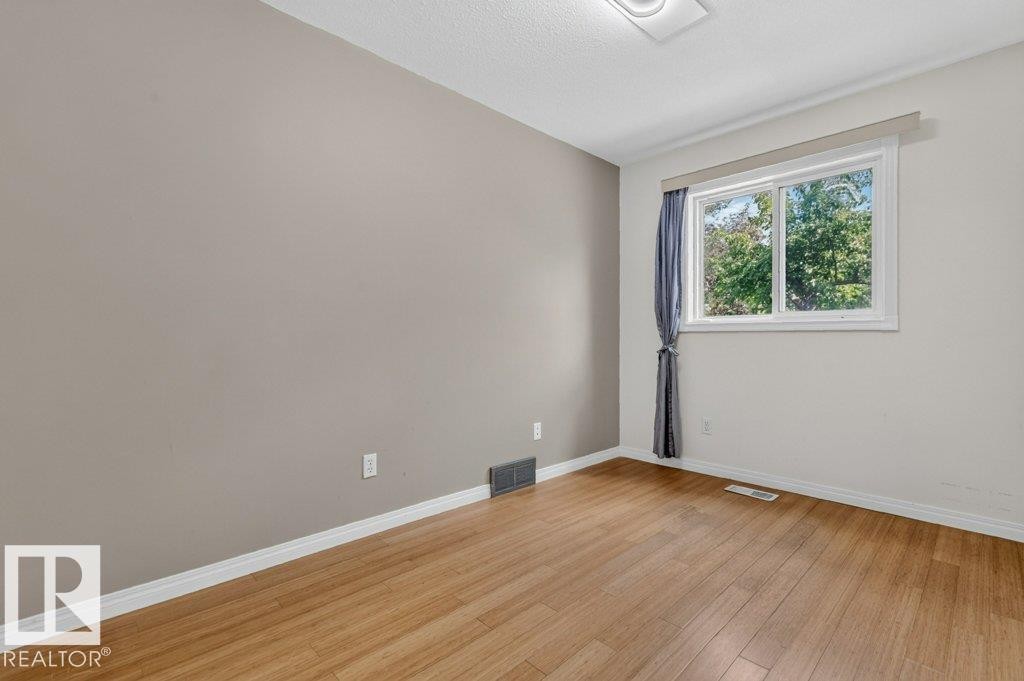 Main floor office featuring hardwood. - 16524 99 Street Nw, Edmonton, AB - Indoor Photo Showing Other Room