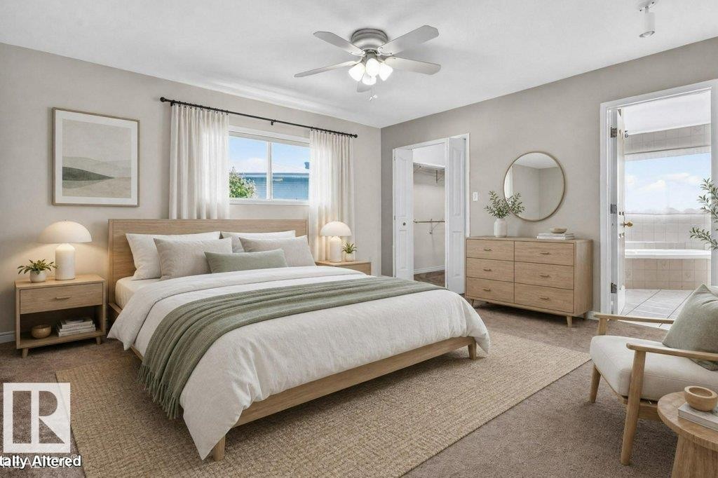 Carpeted bedroom with a ceiling fan, a window with exterior views, and a walk-in closet featuring double doors - 16524 99 Street Nw, Edmonton, AB - Indoor Photo Showing Bedroom