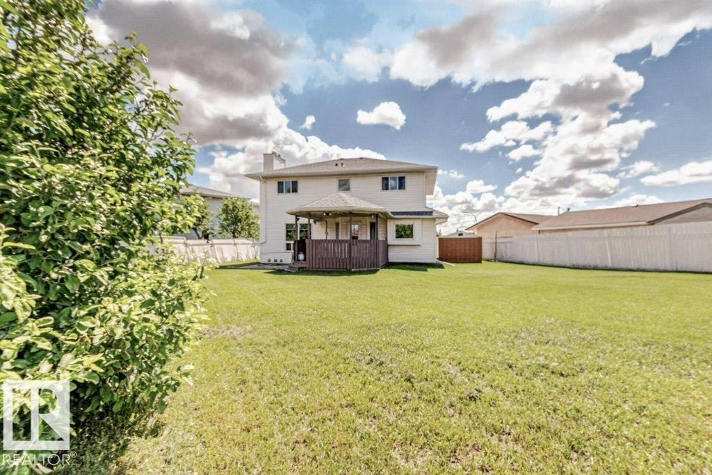 Expansive green lawn providing ample outdoor space - 16524 99 Street Nw, Edmonton, AB - Outdoor With Deck Patio Veranda