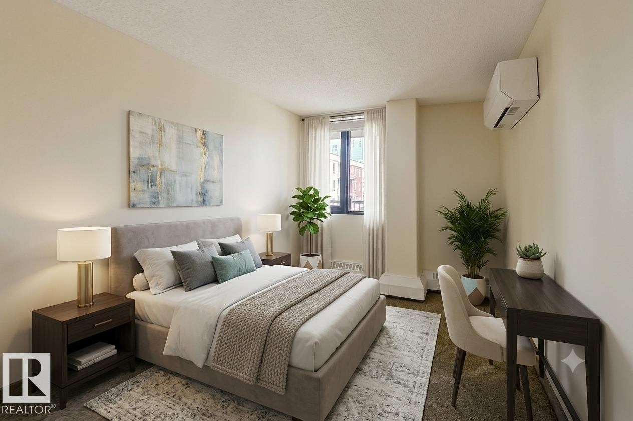 Bedroom featuring soft cream walls and a textured ceiling - 505 10145 109 Street, Edmonton, AB