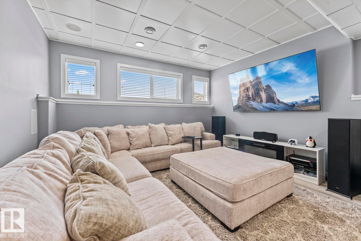Finished room featuring a coffered ceiling with recessed lighting, crown molding, and multiple windows with blinds - 35 Falcon Road, Cold Lake, AB