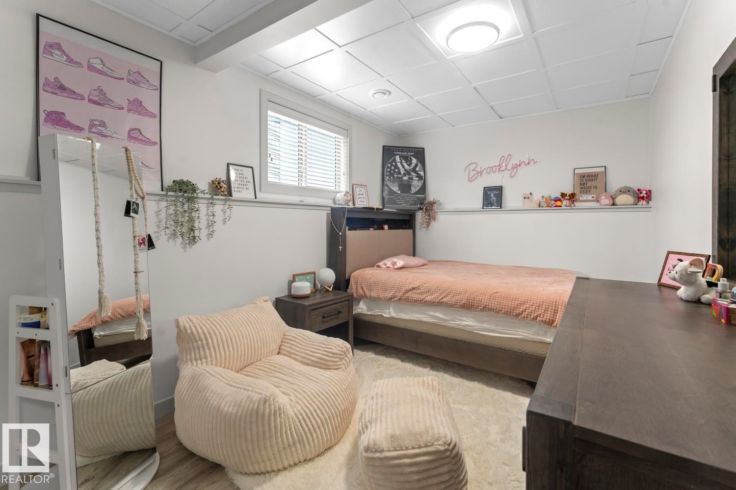 White walls frame this bedroom with a window offering natural light - 35 Falcon Road, Cold Lake, AB