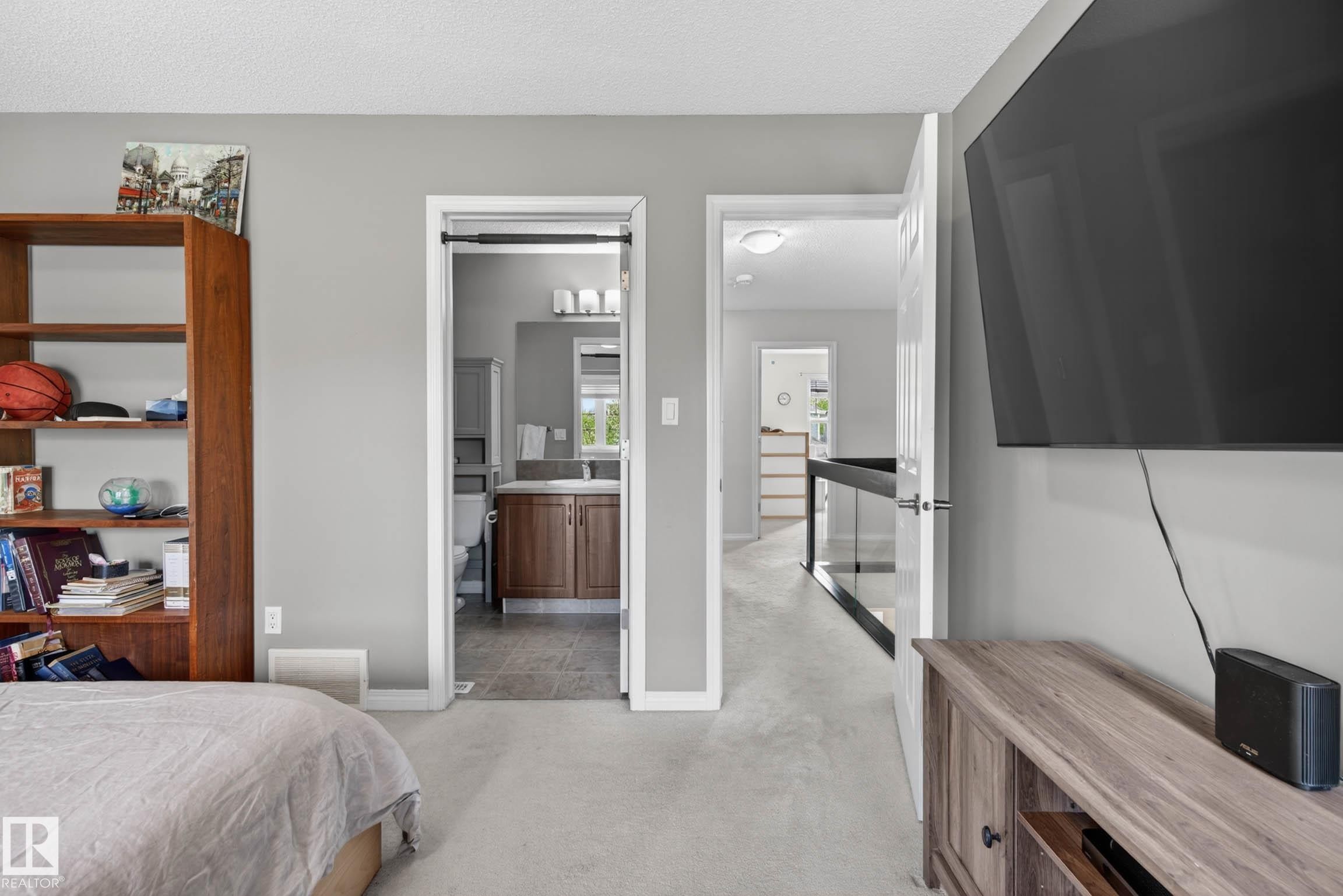 Carpeted interior space with light gray walls, featuring two doorways - 2007 72 Street, Edmonton, AB - Indoor Photo Showing Bedroom