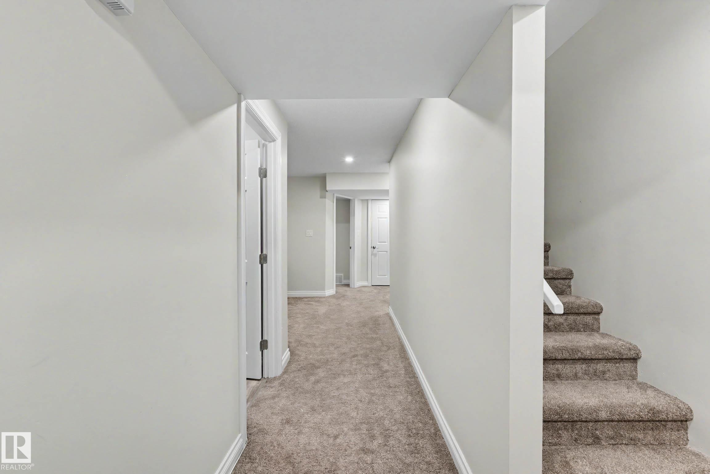 Carpeted hallway featuring white trim and matching interior doors - 2007 72 Street, Edmonton, AB - Indoor Photo Showing Other Room