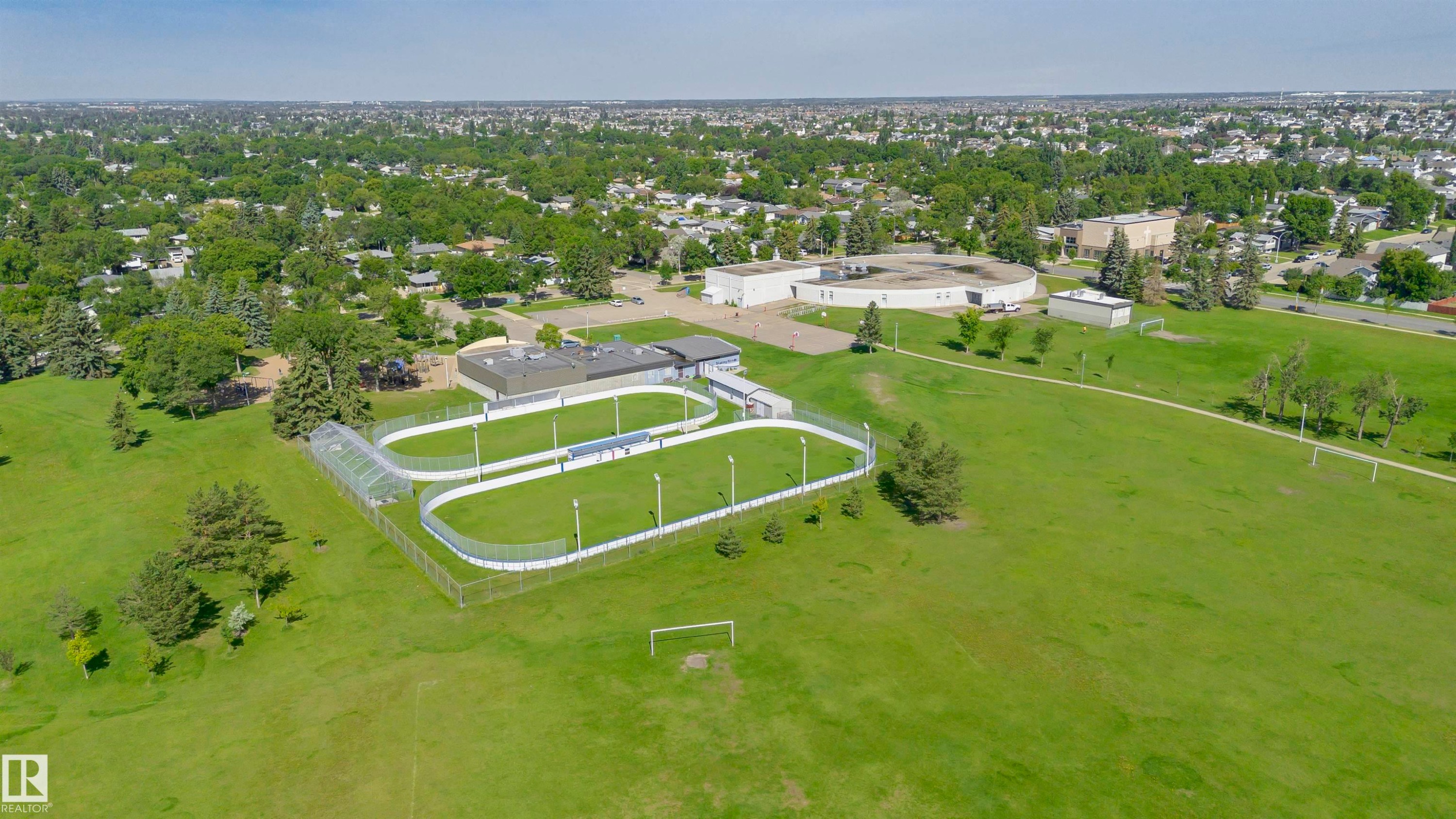 Expansive green space featuring multiple sports fields and a fenced track facility - 5418 144B Avenue, Edmonton, AB
