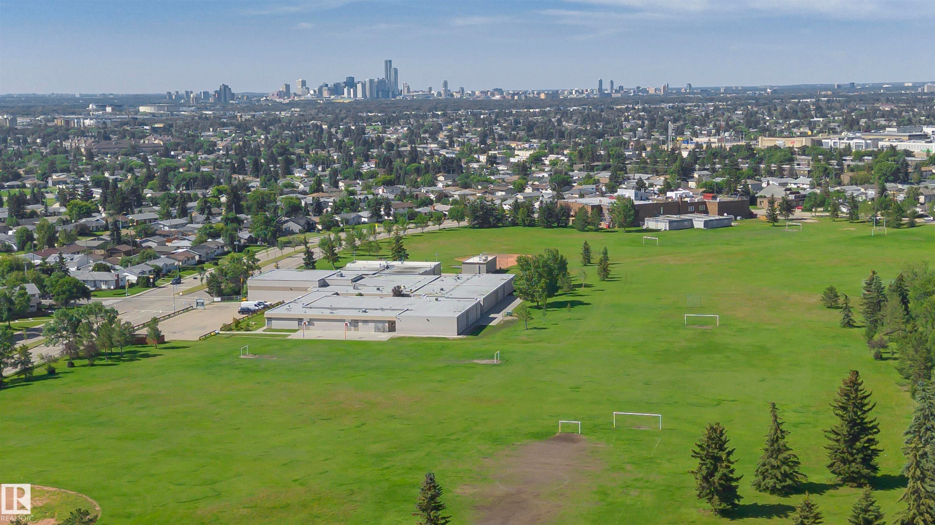 Expansive green space featuring multiple soccer goals and mature evergreen trees - 5418 144B Avenue, Edmonton, AB