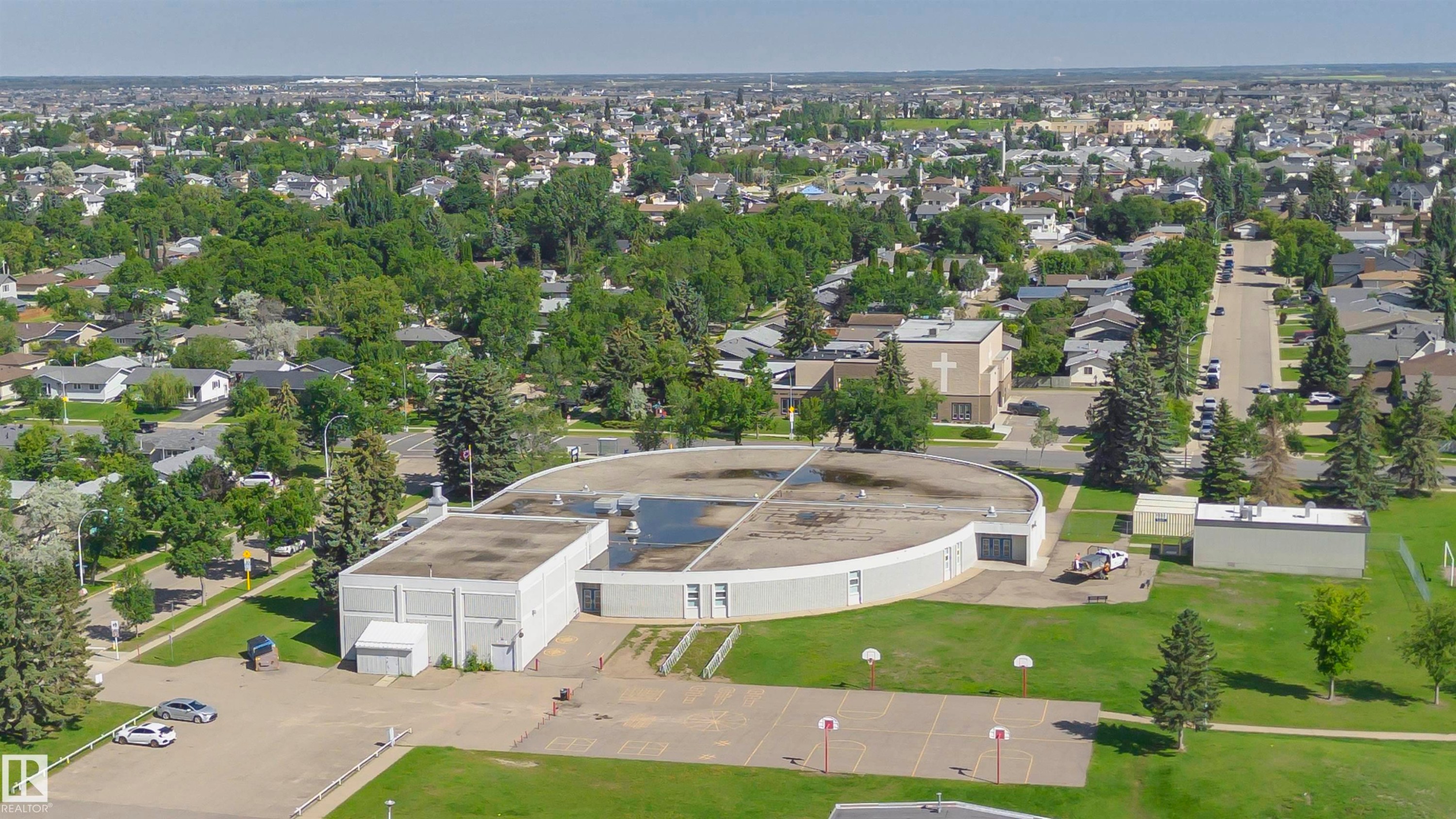 Expansive aerial perspective showcasing a neighborhood with mature trees - 5418 144B Avenue, Edmonton, AB