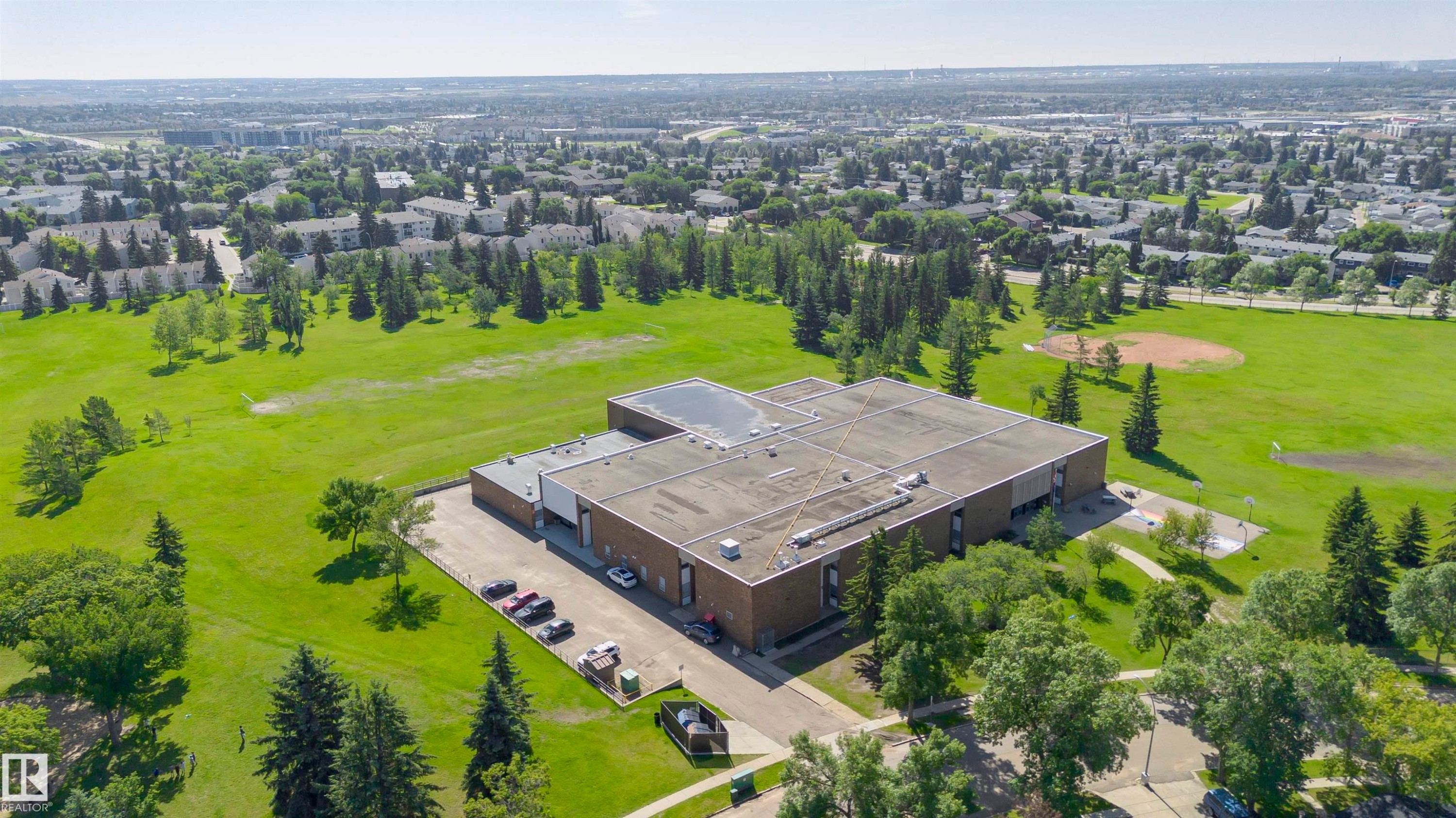 Expansive institutional building featuring a flat roof and brick facade - 5418 144B Avenue, Edmonton, AB