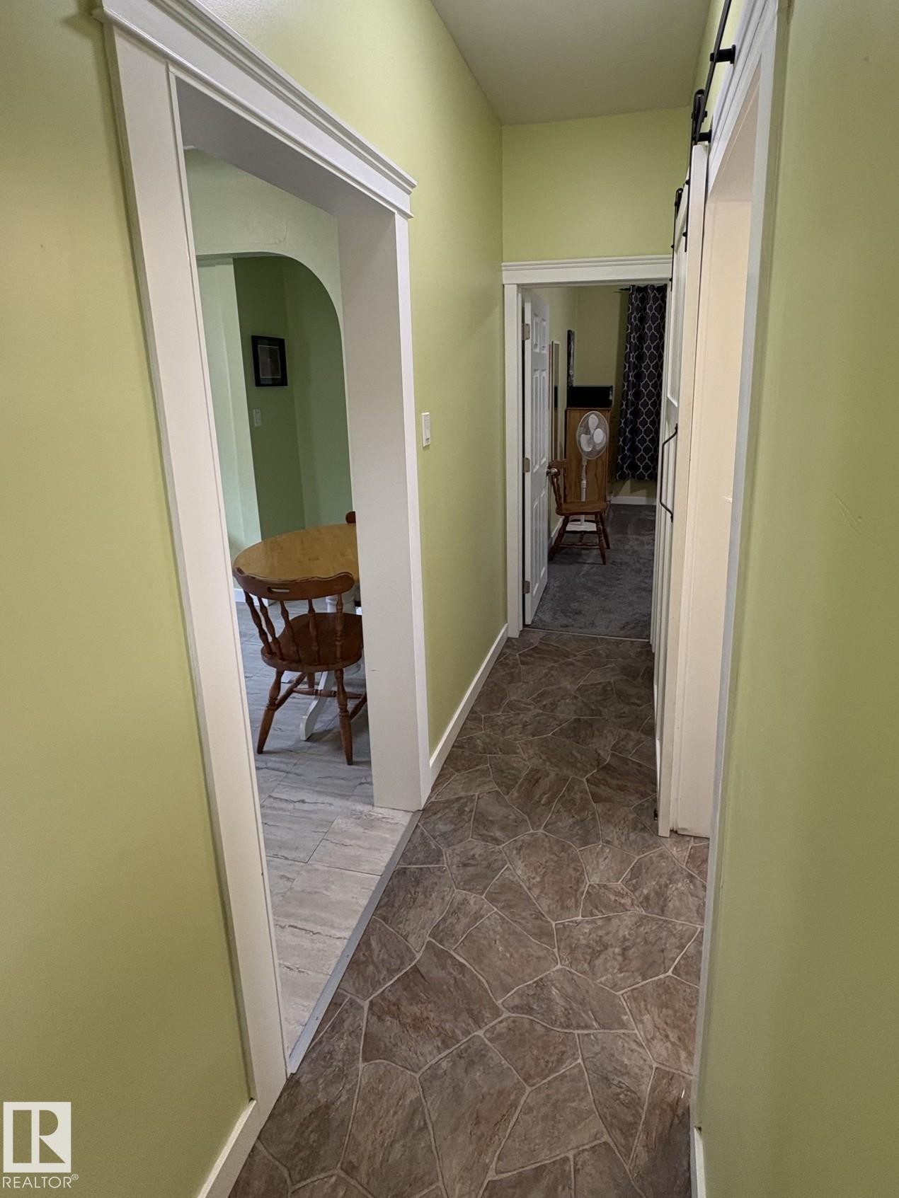 Hallway with irregular stone-look flooring, light green walls, and white trim - 11511 101 Street, Edmonton, AB