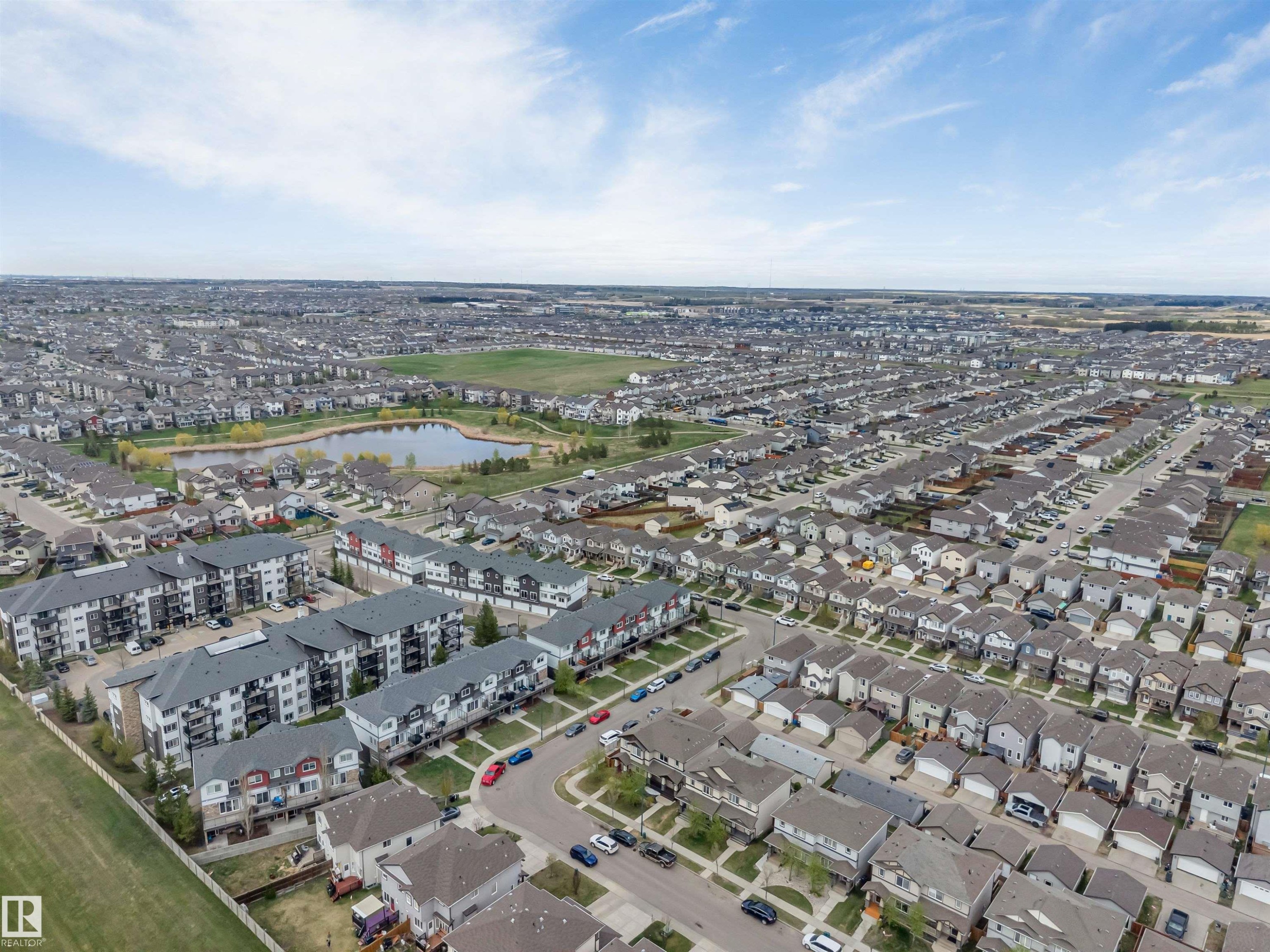 Expansive residential development featuring a variety of housing types, including multi-story apartment buildings and single-family homes - 3340 15A Avenue, Edmonton, AB